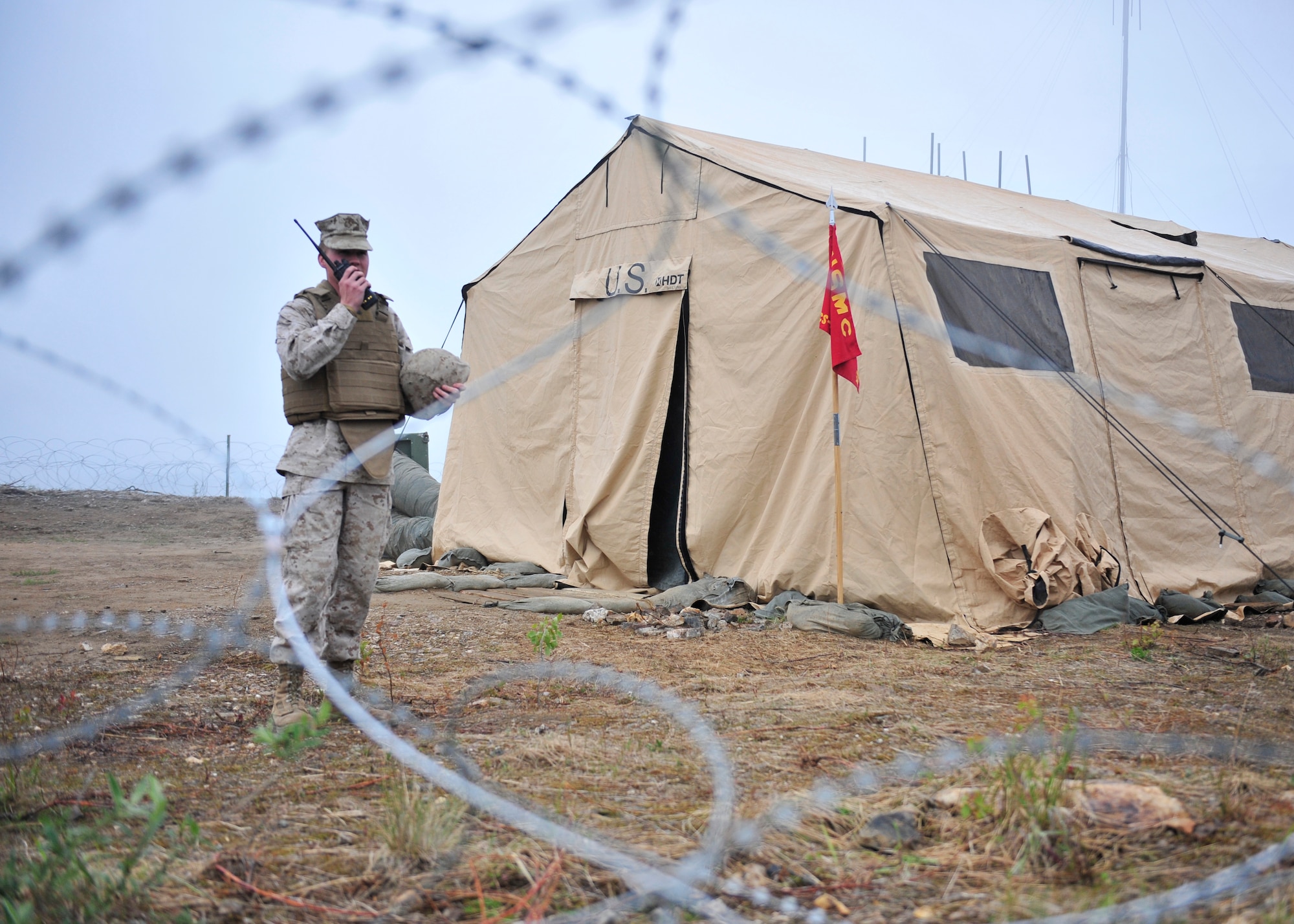 U.S. Marine Corps Cpl. Matthew Throne, Marine Wing Communications Squadron 38 satellite operator assigned to Marine Corps Air Station Cherry Point, N.C., uses a land mobile radio to communicate with other Marines during Red Flag-Alaska 14-2 June 24, 2014, Joint Pacific Alaska Range Complex, Alaska. RF-A provides USMC Air Defense Marines with an opportunity to perform their job during complex real-world scenarios. (U.S. Air Force photo by Senior Airman Ashley Nicole Taylor/Released)