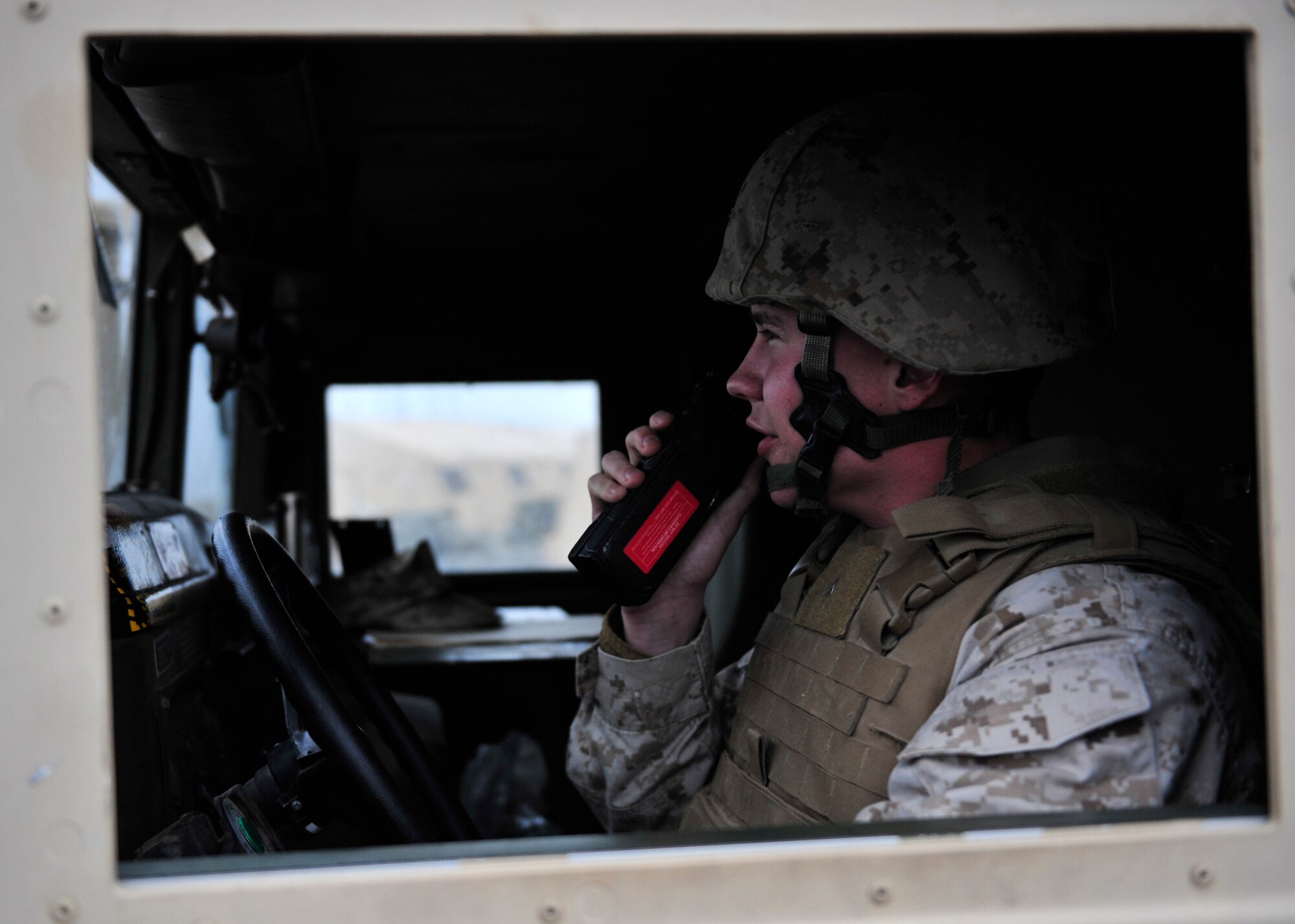 U.S. Marine Corps Cpl. Matthew Throne, Marine Wing Communications Squadron 38 satellite operator assigned to Marine Corps Air Station Cherry Point, N.C., uses a land mobile radio to communicate with other Marines during Red Flag-Alaska 14-2 June 24, 2014, Joint Pacific Alaska Range Complex, Alaska. The Marines’ mission was to provide air surveillance, air control and information exchange in the form of Link-16 digital interoperability in support of a multinational exercise. (U.S. Air Force photo by Senior Airman Ashley Nicole Taylor/Released)