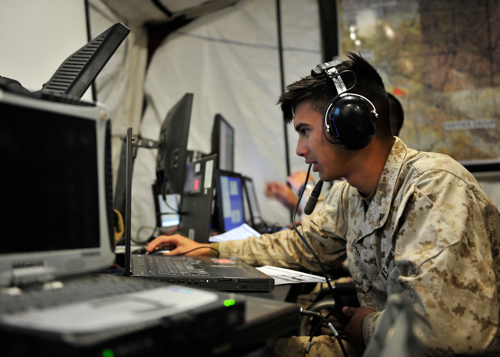 U.S. Marine Corps Lance Cpl. Alexander Banus, Marine Air Control Squadron 2 radar controller assigned to Marine Corps Air Station Cherry Point, N.C., communicates with an aircraft during Red Flag-Alaska 14-2 June 24, 2014, Joint Pacific Alaska Range Complex, Alaska. RF-A provided the Marine Air Control Agency with a live flight venue that has more aircraft flying during each event and gave operators a better feel of what they can expect in a combat situation (U.S. Air Force photo by Senior Airman Ashley Nicole Taylor/Released)