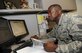 Staff Sgt. Joseph Boyou, 2nd Air Force, reviews slides for a final review session for 2nd AF, 81st Training Wing and the 81st Training Group July 1, 2014, at Keesler Air Force Base, Miss.  Boyou was born in Liberia, West Africa and escaped the civil war there when he was a child. Boyou wrote a memoir telling his story of overcoming adversity. It is scheduled to be released later this summer. (U.S. Air Force photo by Kemberly Groue)