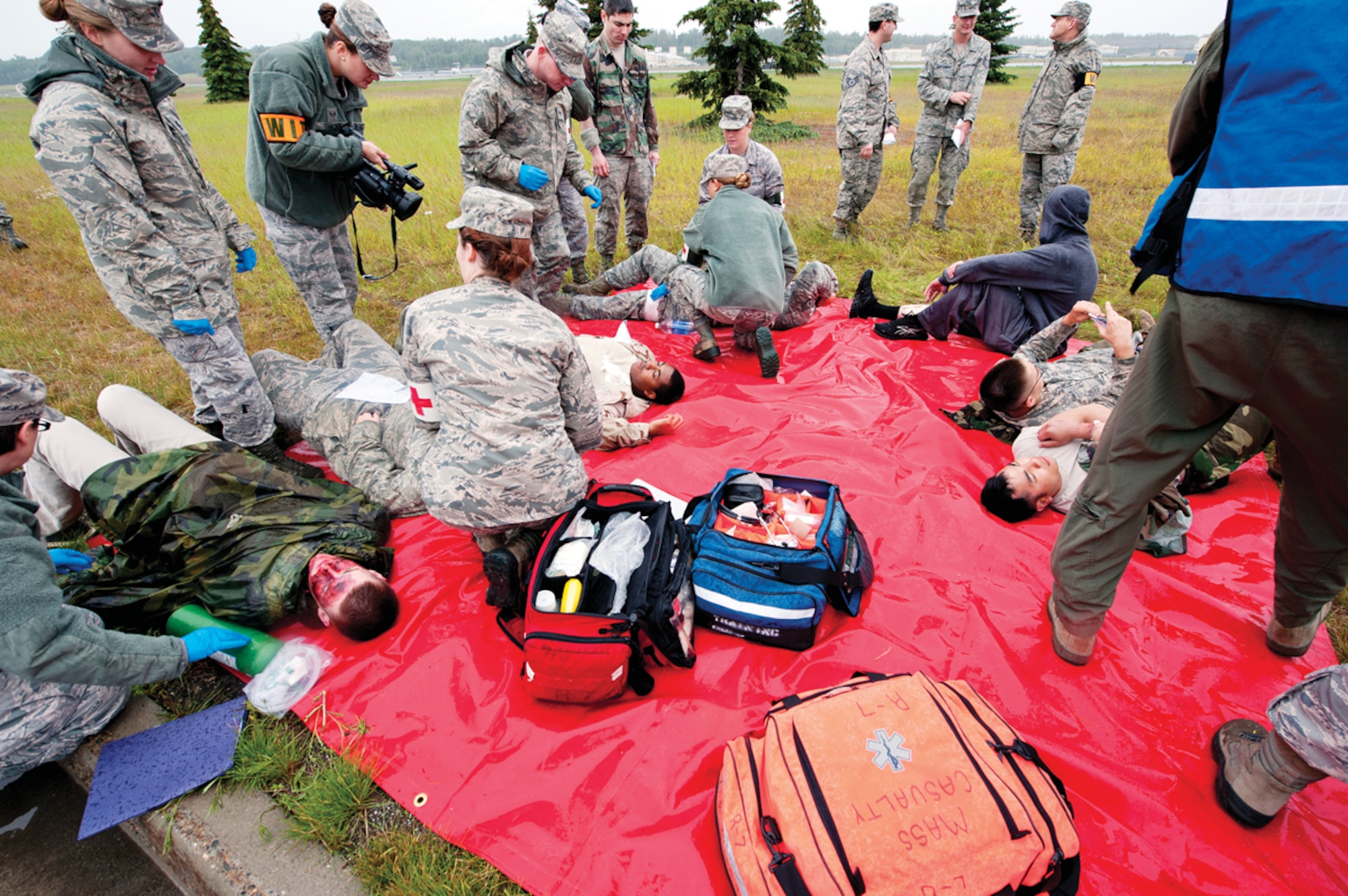 Medical responders tend to simulated victim’s wounds during the annual mission assurance exercise on Joint Base Elmendorf-Richardson, Alaska, June 26, 2014. Victims were treated separately on different colored tarps depending on how severe their injuries were and sent to the hospital shortly after for further treatment. (U.S. Air Force photo/Airman 1st Class Tammie Ramsouer)