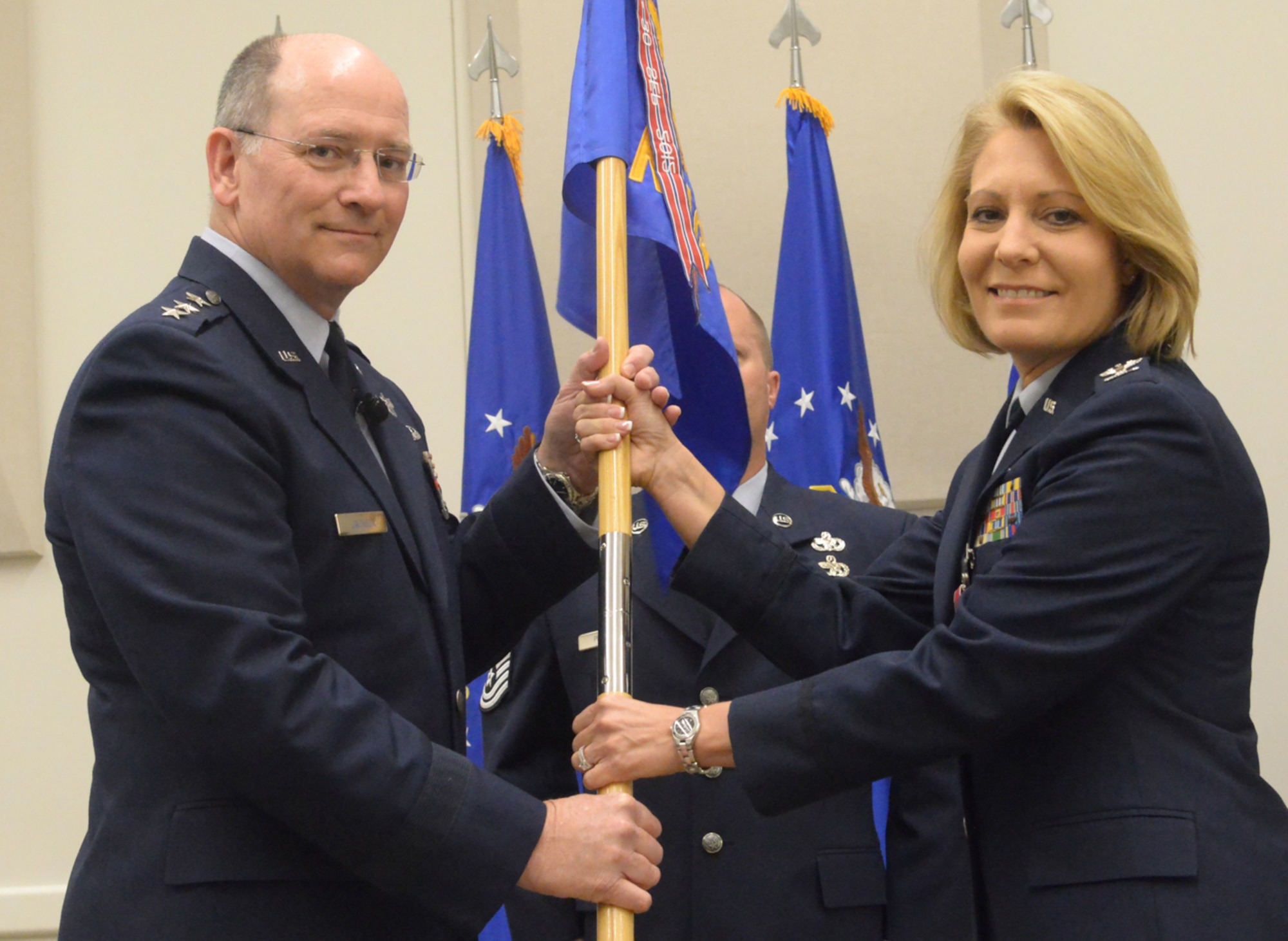 Col. Dawn M. Wallace, Readiness Management Group commander, presents the RMG flag to Lt. Gen. James F. Jackson, chief of Air Force Reserve and commander of Air Force Reserve Command, for encasement during the RMG inactivation ceremony at Robins Air Force Base, Ga., July 1, 2014. The RMG was created in April 2005 at the base to centralize the management of the command’s individual mobilization augmentees. (U.S. Air Force photo/Ray Crayton)