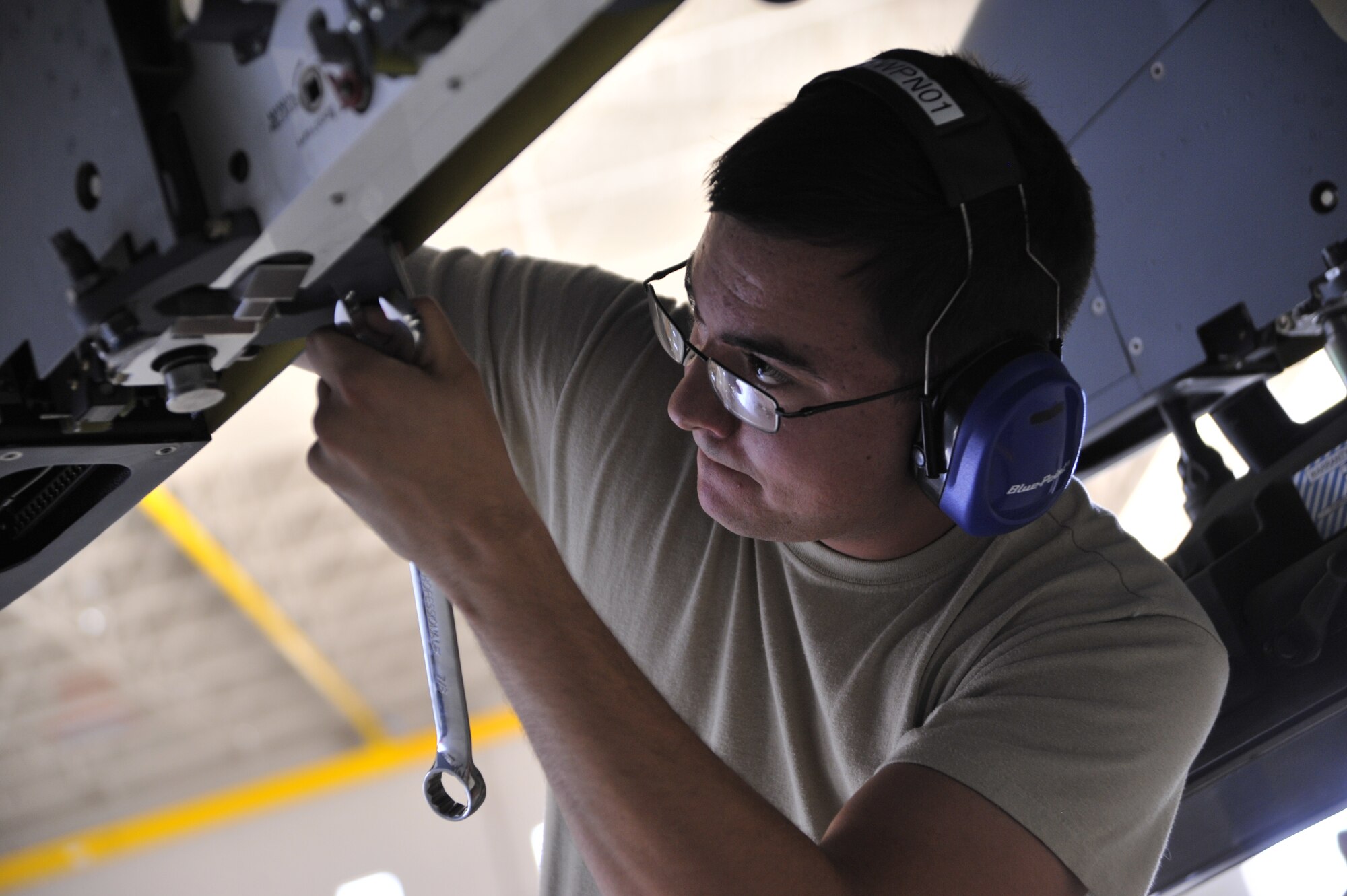 Senior Airman Devin Milburn, 432nd Aircraft Maintenance Squadron support technician, prepares an MQ-9 Reaper for loading a GBU-12 Paveway laser guided bomb during a load crew competition at Creech Air Force Base, Nev., June 30, 2014. The competition takes place every quarter, with a fifth competition taking place at the end of each year to determine the load crew of the year. (U.S. Air Force photo by Airman 1st Class Christian Clausen/Released)