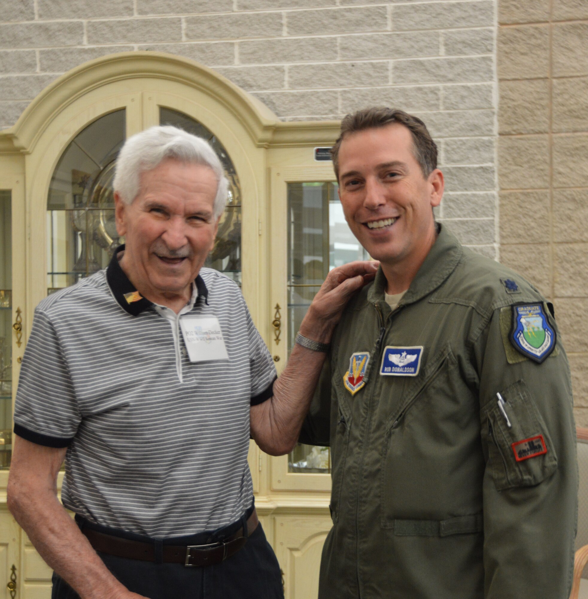 William Decker, a former Navy Petty Officer Second Class who served during World War II, shares a laugh with his military escort,  Lt. Col. Robert Donaldson of  the Air Forces Northern Commander's Action Group. (Photo by Mary McHale)