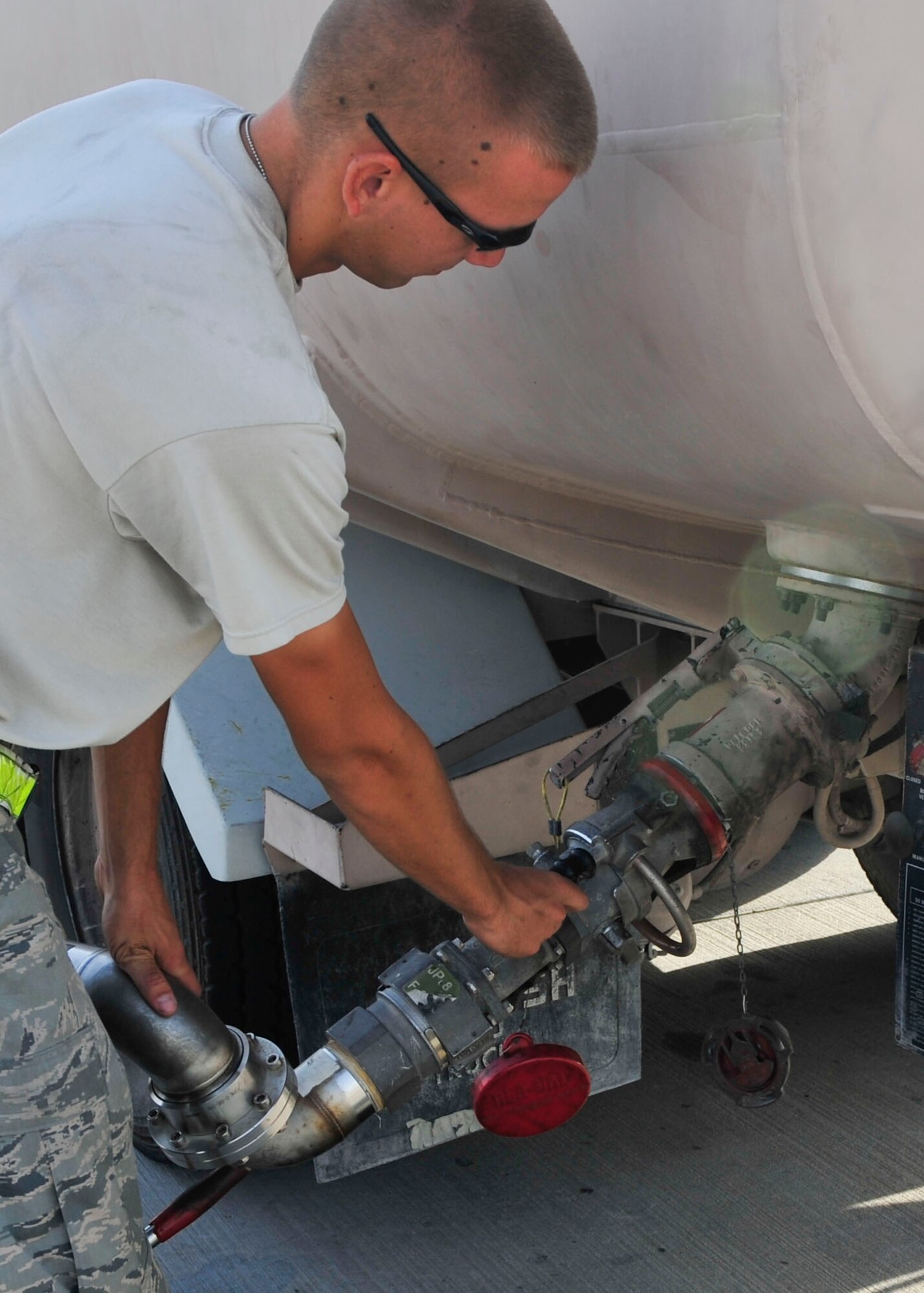 U.S Air Force Senior Airman Kyle Schmitt, 379th Expeditionary Logistics Readiness Squadron fuels distribution operator, fills a fuel truck with JP-8 from a hydrant system at Al Udeid Air Base, Qatar, June 30, 2014. The hydrant system allows the fuels operators to keep their vehicles on the flightline and keep the mission going. Schmitt is deployed from Joint Base McGuire-Dix-Lakehurst, New Jersey, and his hometown is Toms River, New Jersey. (U.S. Air Force photo by Senior Airman Colin Cates)