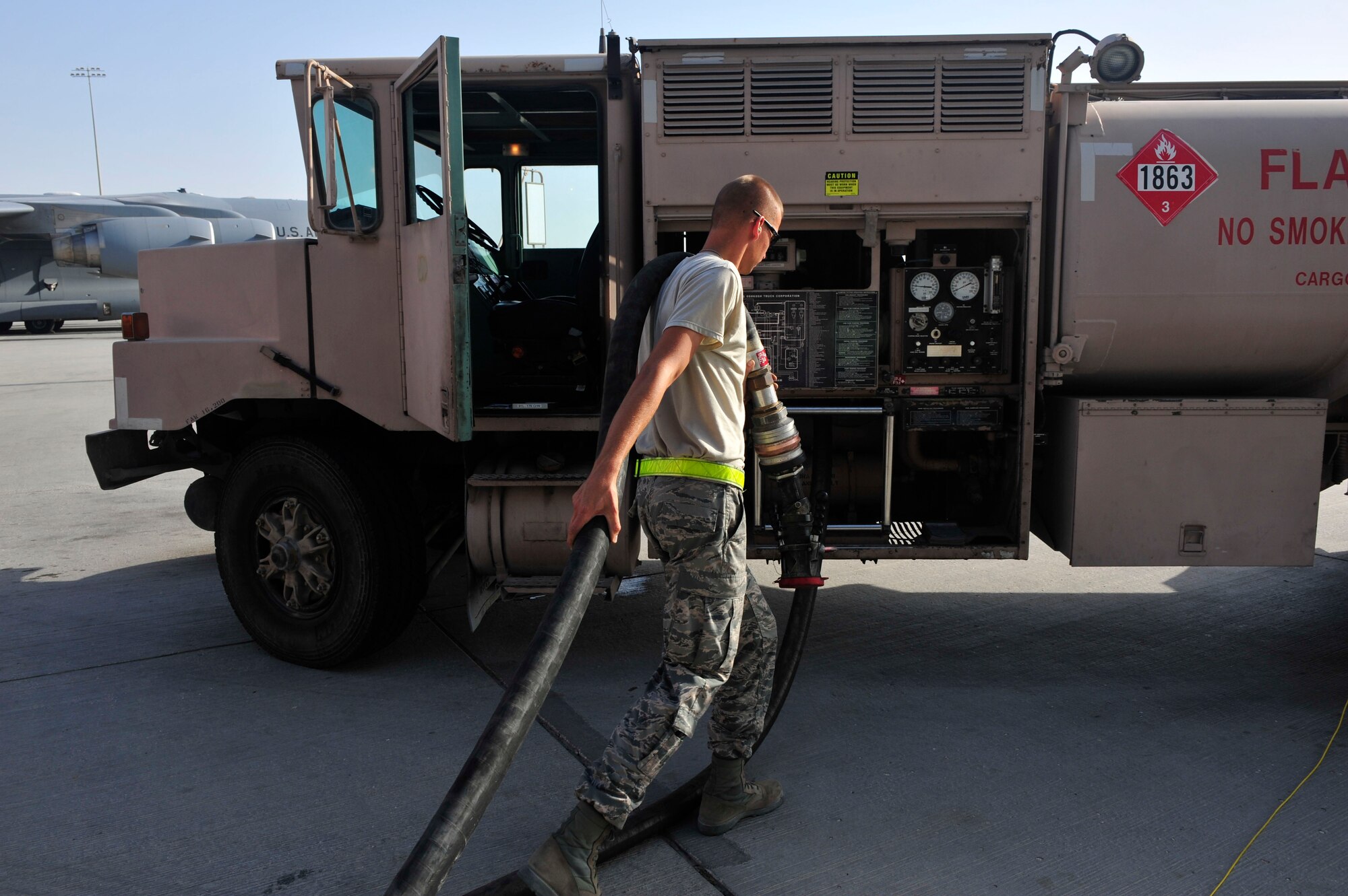 U.S Air Force Senior Airman Kyle Schmitt, 379th Expeditionary Logistics Readiness Squadron fuels distribution operator, returns the hose to the truck at Al Udeid Air Base, Qatar, June 30, 2014. The average fuels operator will spend nearly half a day on the flight line. Schmitt is deployed from Joint Base McGuire-Dix-Lakehurst, New Jersey, and his hometown is Toms River, New Jersey. (U.S. Air Force photo by Senior Airman Colin Cates)