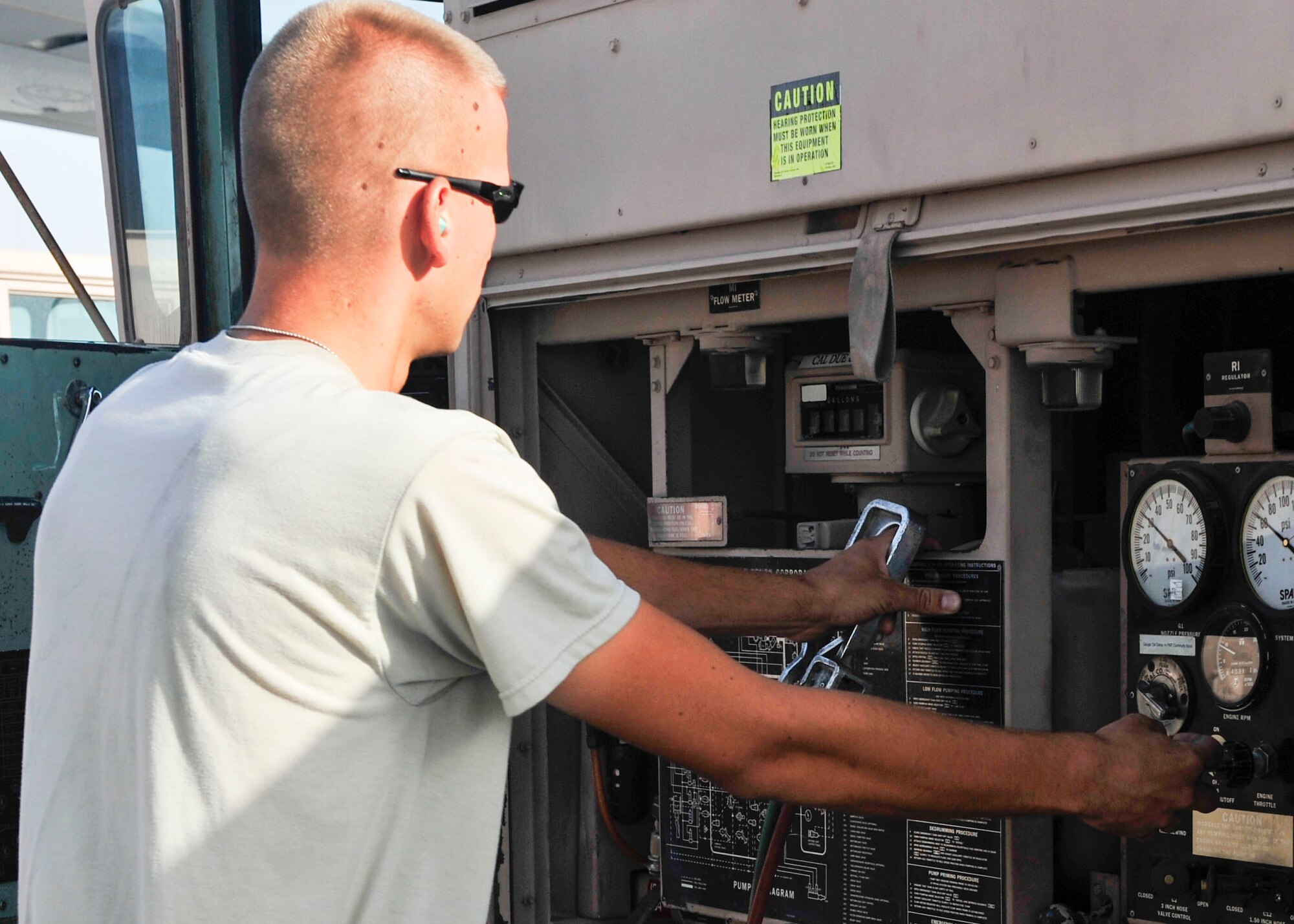 U.S. Air Force Senior Airman Kyle Schmitt, 379th Expeditionary Logistics Readiness Squadron fuels distribution operator, checks the gauges on a fuel truck at Al Udeid Air Base, Qatar, June 30, 2014. Schmitt has pumped nearly a million gallons of jet fuel, known as JP-8 during the past few months here. Schmitt is deployed from Joint Base McGuire-Dix-Lakehurst, New Jersey and his hometown is Toms River, New Jersey. (U.S. Air Force photo by Senior Airman Colin Cates)
