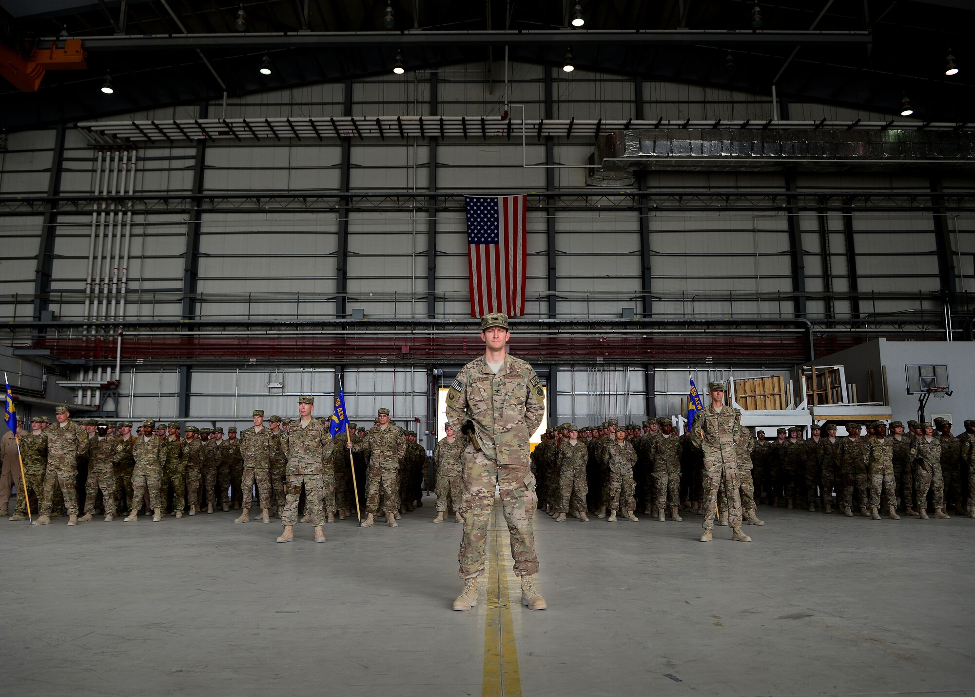 U.S. Airmen from the 455th Air Expeditionary Wing stand at parade rest during the wing’s change of command ceremony at Bagram Airfield, Afghanistan July 3, 2014.  Airmen across the wing attended the ceremony to welcome Brig. Gen. Mark Kelly as their new commander.  (U.S. Air Force photo by Staff Sgt. Evelyn Chavez/Released)