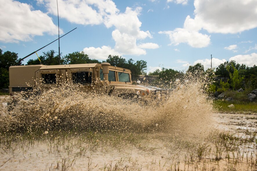 Airmen from the 3d Weather Squadron drive a Humvee through a swamp at Fort Hood, Texas, June 27, 2014. The vehicle weighs approximately 17,000 pounds and is used to prepare for convoy operations. (U.S. Air Force photo by Airman 1st Class Ryan Callaghan/Released)