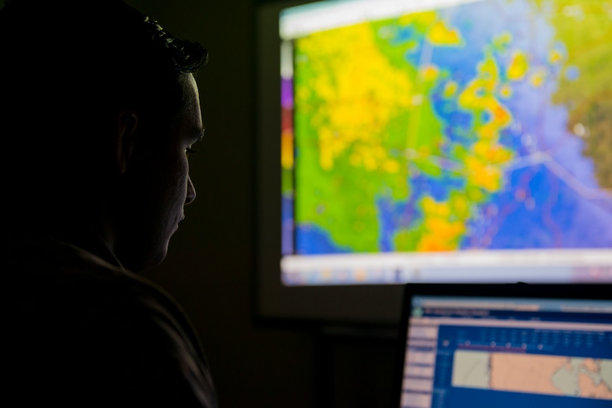 U.S. Air Force Senior Airman Mark Veale, 3d Weather Squadron weather forecaster, evaluates weather patterns at Fort Hood, Texas, June 24, 2014.  The 3d WS provides weather reports for more than 330 square miles of central Texas. (U.S. Air Force photo by Airman 1st Class Ryan Callaghan/Released)