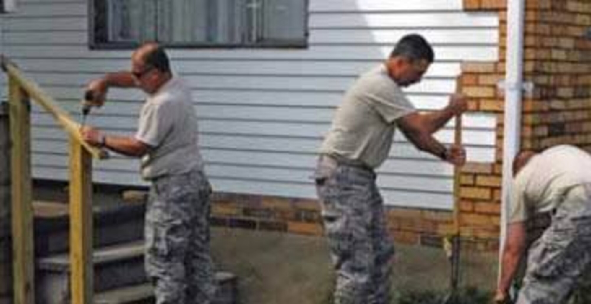 A group of Airmen assists in making repairs around a home as part of an effort by Heroes Supporting Heroes. HSH was started by Senior Master Sgt. John Lee and his wife, Sheri, as a volunteer program to support the families of currently deployed 911th Airmen. If interested in volunteering with HSH or donating funds please visit, www.heroessupportingheroes.org (Courtesy photo)