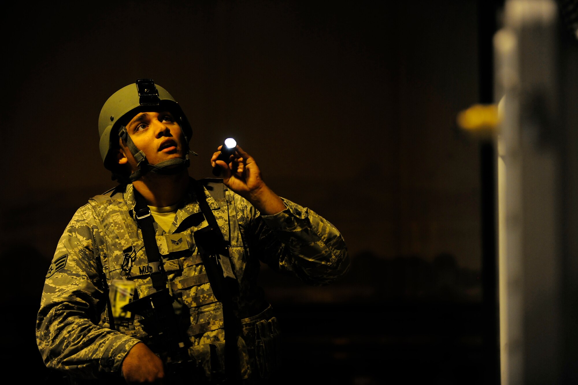 Senior Airman Christopher Murray, 31st Security Forces Squadron security response team member, checks a protected aircraft shelter during an exercise, July 1, 2014, at Aviano Air Base, Italy. To ensure the defenders remain highly proficient in their job, they are tested regularly with frequent exercises. (U.S. Air Force photo/Airman 1st Class Ryan Conroy) 