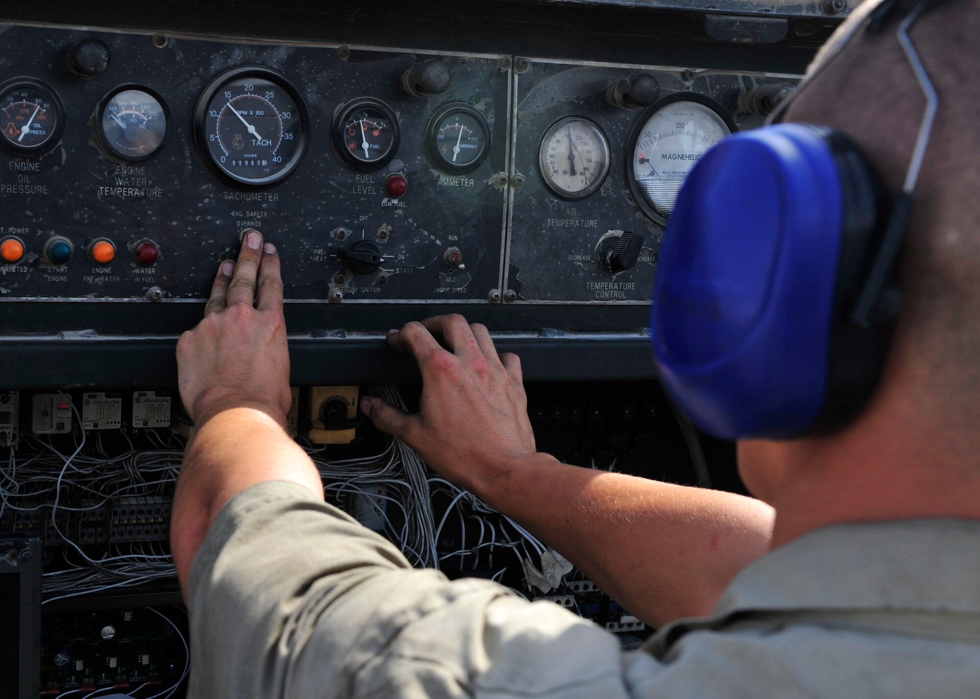 U.S. Air Force Senior Airman Kyle Taylor, 379th Expeditionary Maintenance Squadron Aerospace Ground Equipment maintenance journeyman, performs a generator test at Al Udeid Air Base, Qatar, June 30, 2014. The AGE flight duplicates aircraft systems while on the ground, which include cooling, electrical power generation and hydraulics. Taylor is deployed from Aviano Air Base, Italy and his hometown is Kenton, Ohio. (U.S. Air Force photo by Senior Airman Colin Cates)
