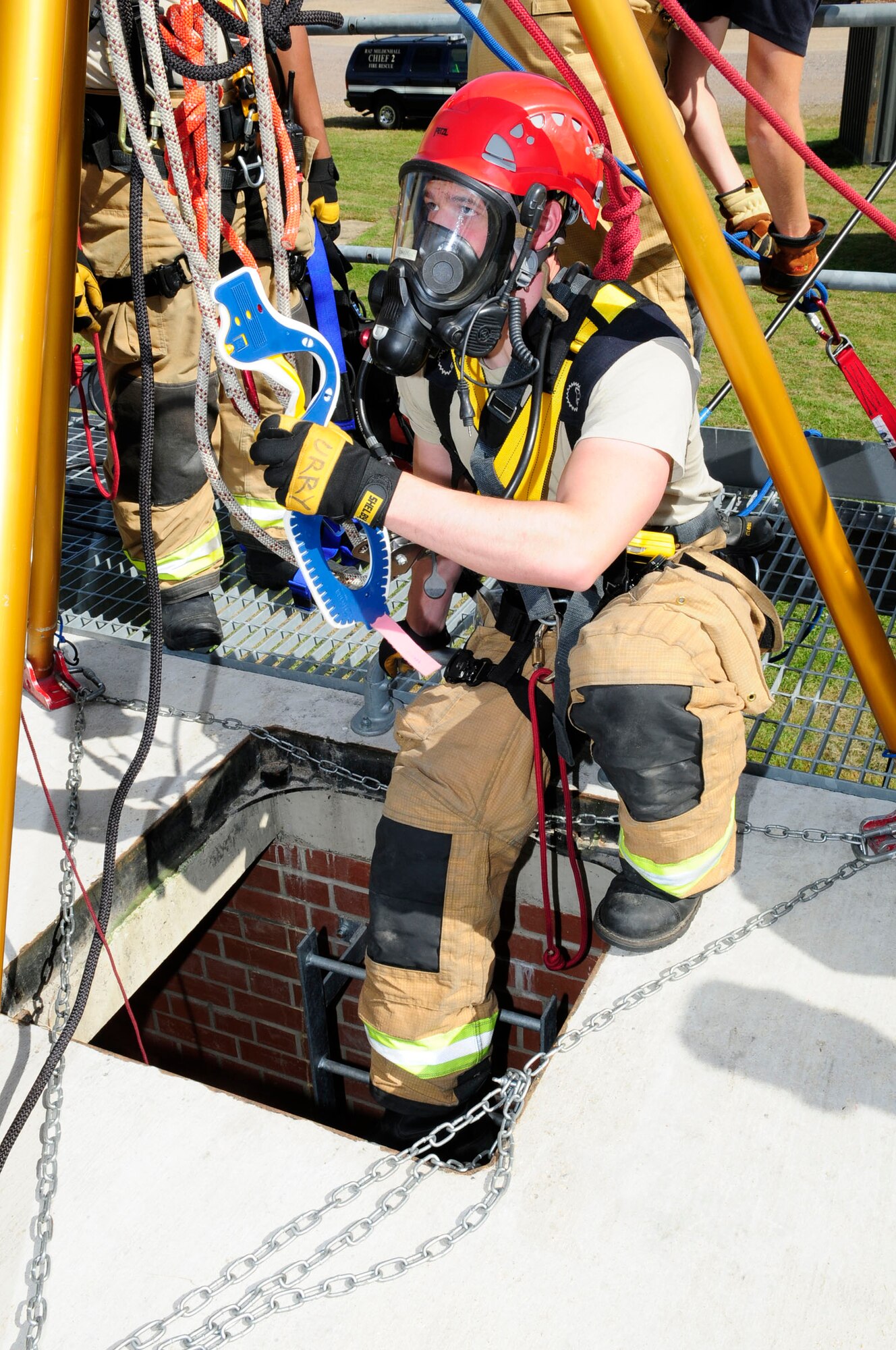 U.S. Air Force Senior Airman Jacob Urry, 100th Civil Engineer Squadron Fire Department firefighter and driver/operator from Kennewick, Wash., prepares to enter a confined space during training as part of a U.S. Air Forces in Europe inspection June 26, 2014, at the fire training area on RAF Mildenhall, England. Urry took a cervical collar into the confined space to place on a victim for stabilization prior to removal from the hazardous area. (U.S. Air Force photo/Karen Abeyasekere/Released)
