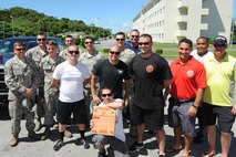 The 18th Civil Engineer Squadron firefighters were awarded the “Battle of the Badge” plaque, Kadena Air Base, Japan, July 3, 2014. The “Battle of the Badge” was a competition between the 18th CES and the 18th Security Forces Squadron in which they faced off in several events including flag football, basketball, and tug-of-war. This was the first “Battle of the Badge” competition on Kadena and is now planned to be held annually. (U.S. Air Force photo by Airman 1st Class Stephen G. Eigel) 
