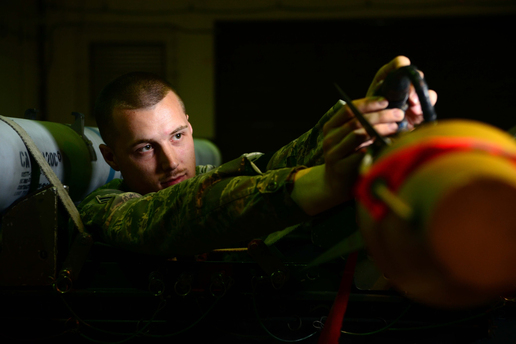 Airman 1st Class Curtis Guay, 35th Maintenance Squadron precision guided munitions crew member, secures an AIM-9X Missile before delivering it to an F-16 Fighting Falcon at Misawa Air Base, Japan, June 11, 2014. Guay is one of about 25 PGM Airmen who supply missiles to the fleet of 44 F-16s at Misawa AB. (U.S. Air Force photo/Senior Airman Derek VanHorn)