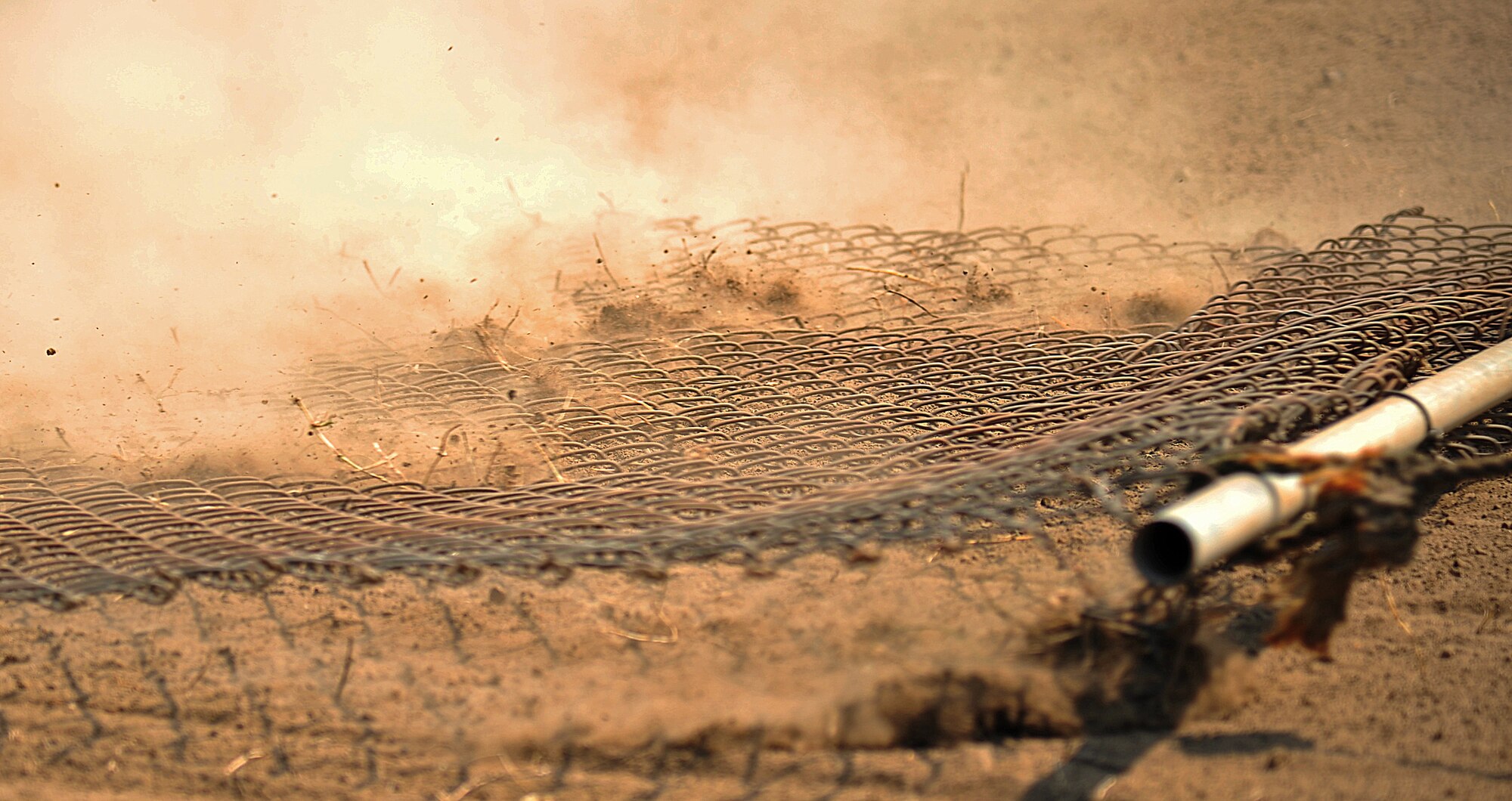 Leftwich Park baseball field soil is groomed using a metal screen at Misawa Air Base, Japan, July 2, 2014. The screen was used to help even out the top layer of soil that was added to the field. (U.S. Air Force photo/Senior Airman Jose L. Hernandez-Domitilo)