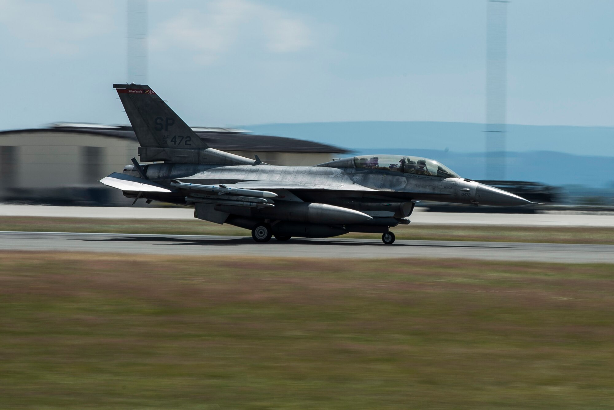 An F-16 Fighting Falcon fighter aircraft assigned to the 52nd Fighter Wing lands at Spangdahlem Air Base, Germany, June 30, 2014. The aircraft returned from integrated training with NATO allies in Poland as part of the persistent presence mission in Eastern Europe and were replaced by U.S. Air Force C-130J Super Hercules cargo aircraft. (U.S. Air Force photo by Staff Sgt. Chad Warren/Released)
