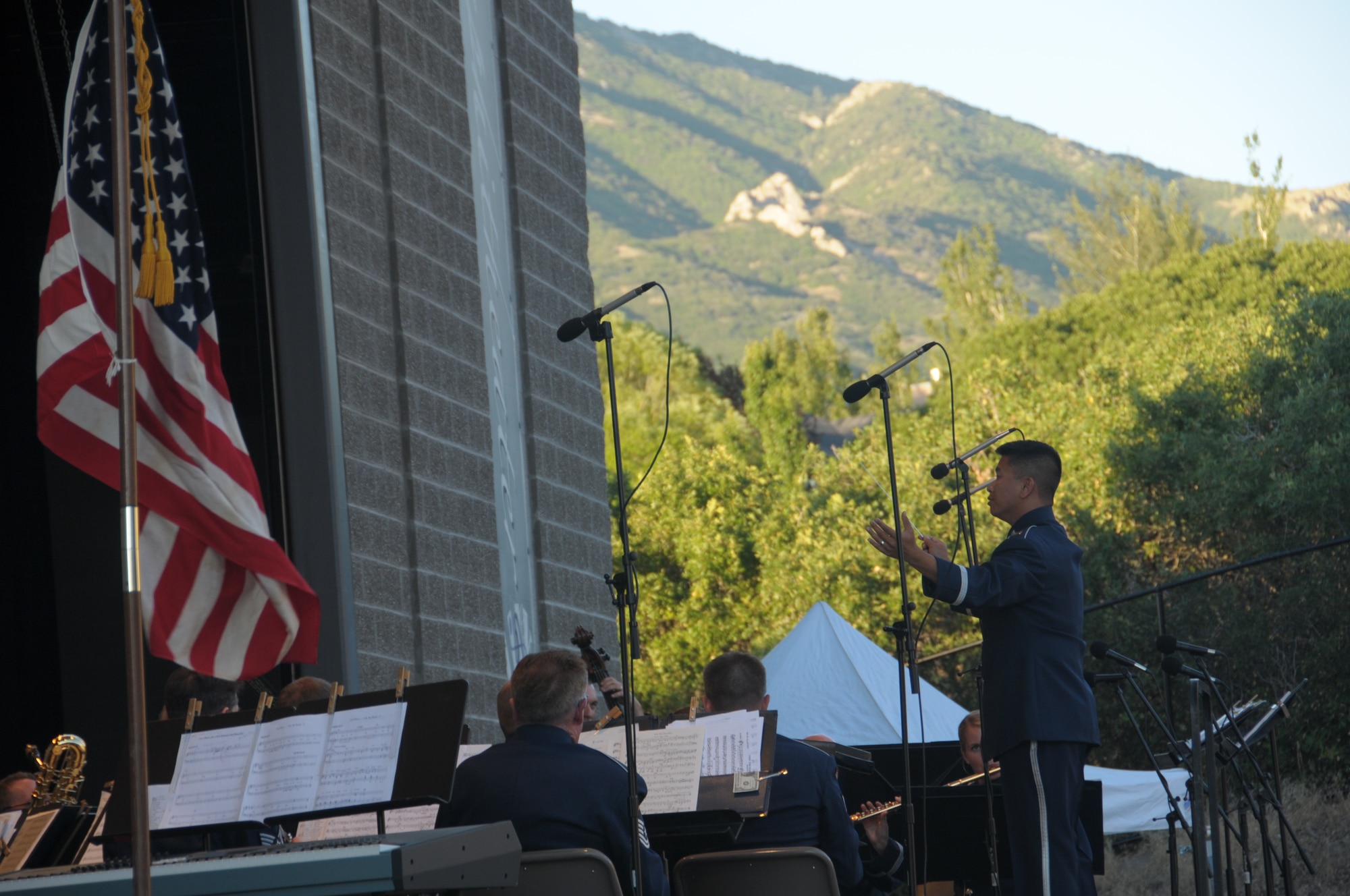 U.S. Air Force Capt. Vu Nguyen, commander of the 562nd Air Force Band of the West Coast, conducts the band at a performance at the Draper City Amphitheater in Draper City, Utah on July 1, 2014. (U.S. Air National Guard photo by Airman 1st Class Madeleine Richards/Released)



