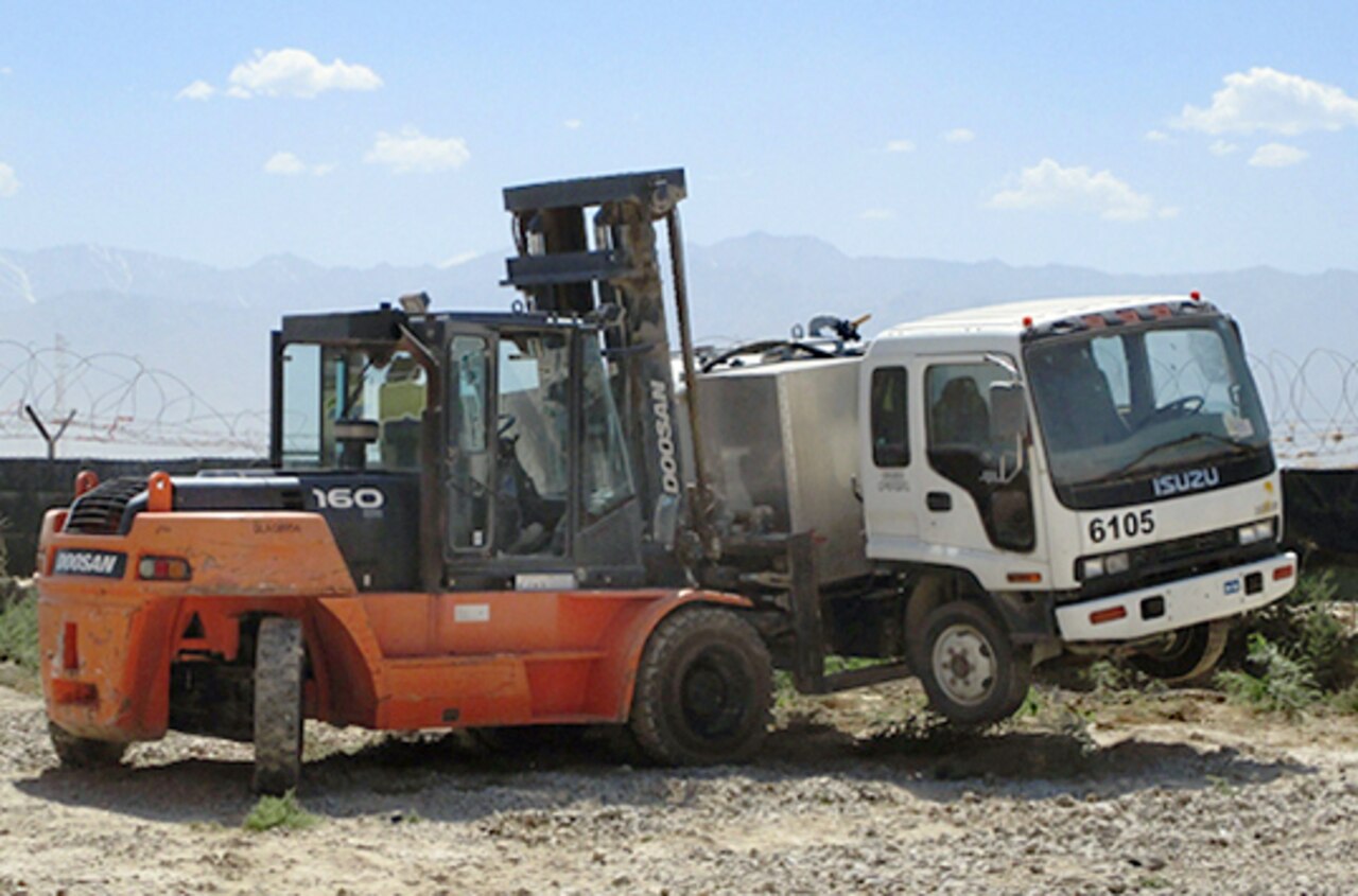 A truck is moved in preparation for the first sale of useable non-military property at Bagram Airfield, Afghanistan, June 25, 2014. Photo by Kathy Wigginton