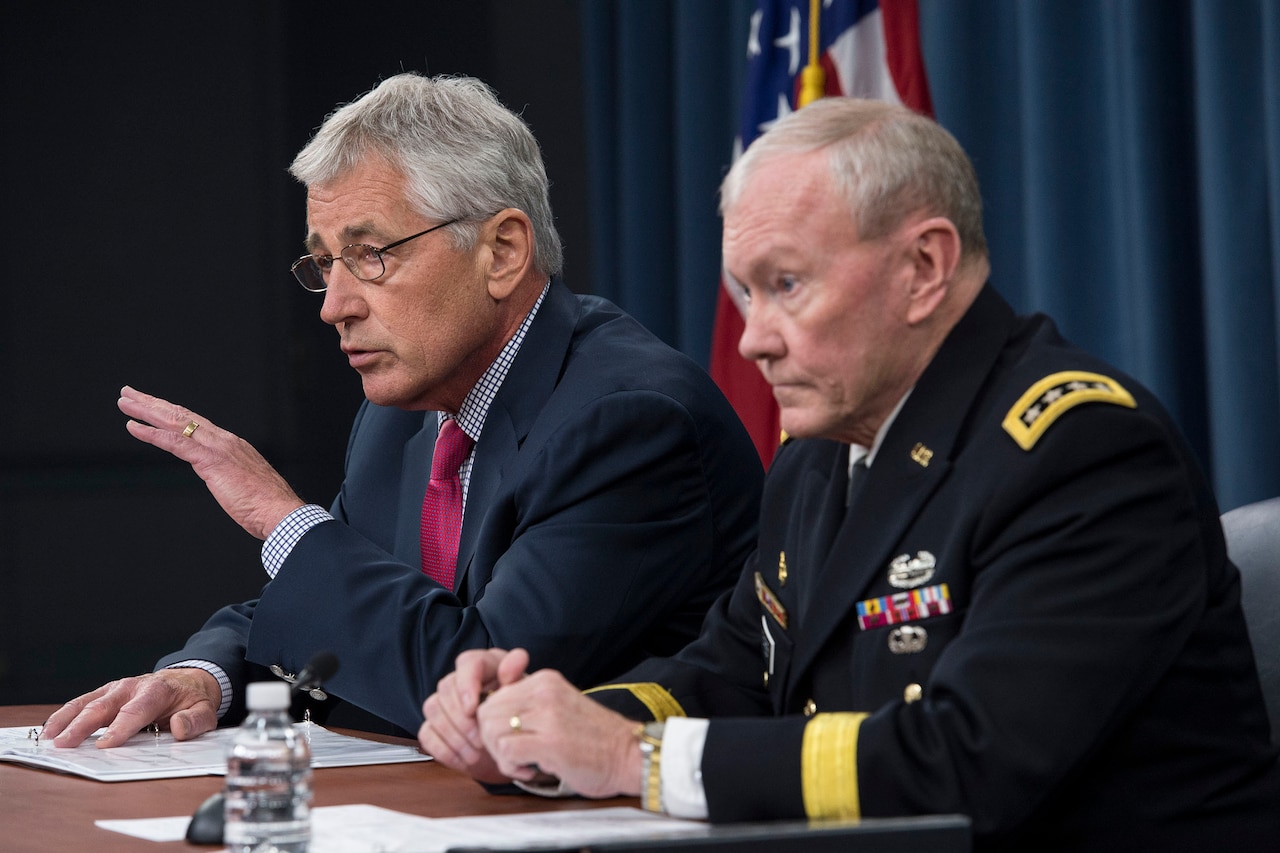 Defense Secretary Chuck Hagel and Army Gen. Martin E. Dempsey, chairman of the Joint Chiefs of Staff, brief reporters at the Pentagon, July 3, 2014. DoD photo by Navy Petty Officer 1st Class Daniel Hinton

