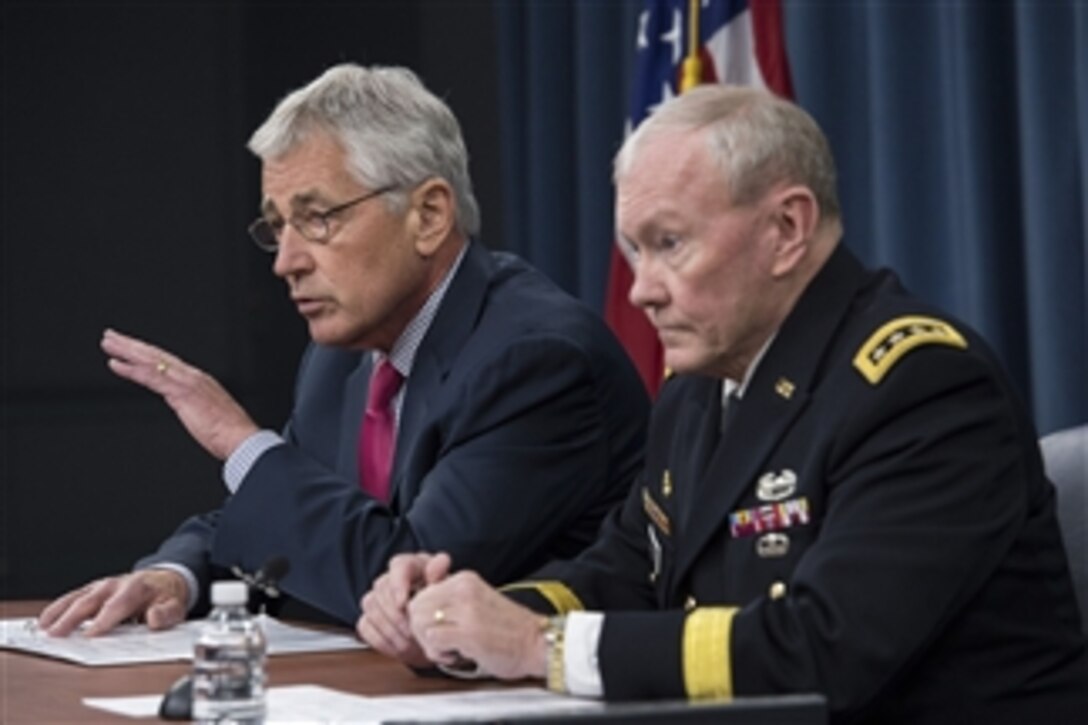 Defense Secretary Chuck Hagel and Army Gen. Martin E. Dempsey, chairman of the Joint Chiefs of Staff, brief reporters at the Pentagon, July 3, 2014. 