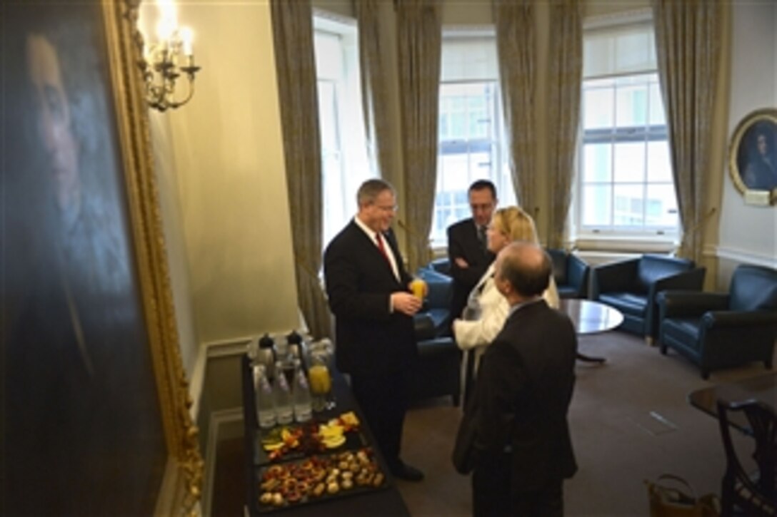 U.S. Deputy Defense Secretary Bob Work, left, meets with senior British defense leaders in London, July 3, 2014. 