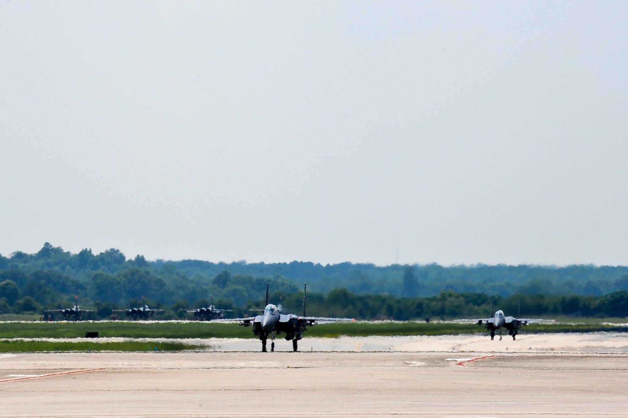 F-15E Strike Eagle aircraft taxi on the flight line, July 4, 2014, at Seymour Johnson Air Force Base, North Carolina. More than 50 Strike Eagle aircraft returned home after being repositioned at Wright Patterson Air Force Base, Ohio, as a precaution for Hurricane Arthur.  (U.S. Air Force photo/Airman 1st Class Aaron J. Jenne)