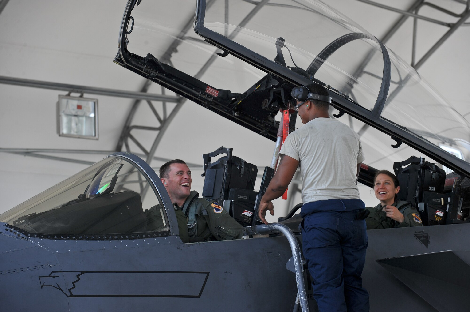 A crew chief assigned to the 4th Aircraft Maintenance Squadron greets the pilot and weapon systems officer of an F-15E Strike Eagle, July 4, 2014, at Seymour Johnson Air Force Base, North Carolina. More than 50 Strike Eagle aircraft returned home after being repositioned at Wright Patterson Air Force Base, Ohio, as a precaution for Hurricane Arthur. (U.S. Air Force photo/Airman 1st Class Aaron J. Jenne)