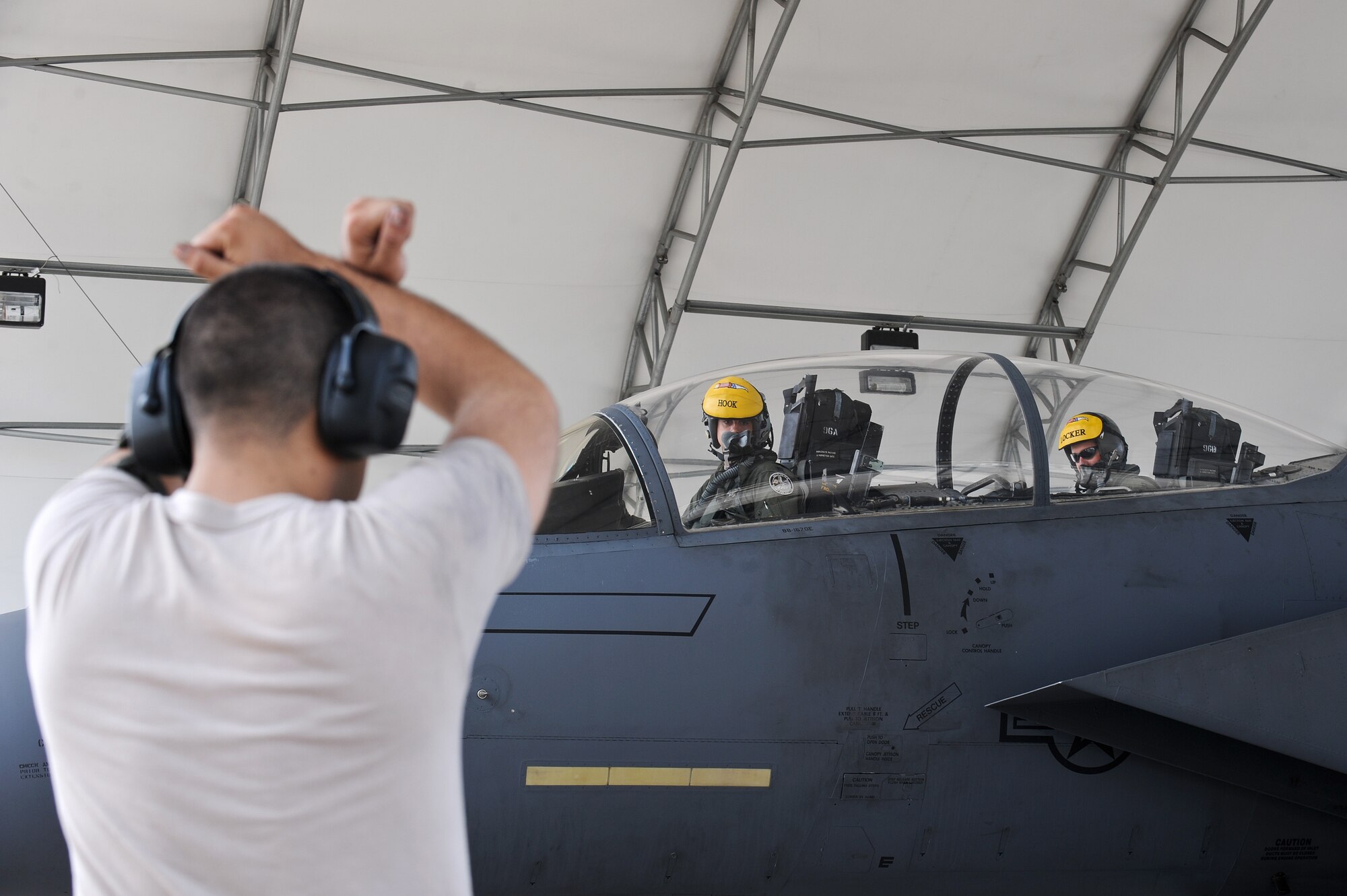 A crew chief assigned to the 4th Aircraft Maintenance Squadron marshals an F-15E Strike Eagle into position July 4, 2014, at Seymour Johnson Air Force Base, North Carolina. More than 50 Strike Eagle aircraft returned home after being repositioned at Wright Patterson Air Force Base, Ohio, as a precaution for Hurricane Arthur. (U.S. Air Force photo/Airman 1st Class Aaron J. Jenne)