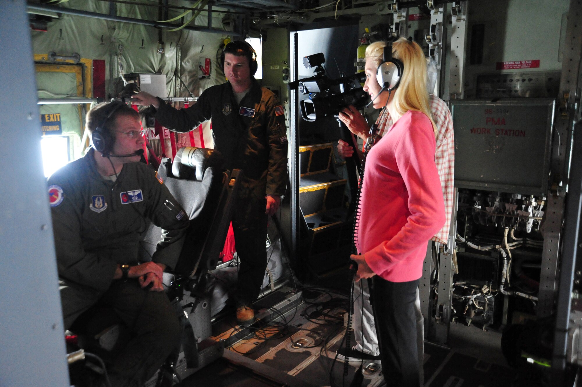 Lt Col. Brian Schroeder, 53rd Weather Reconnaissance Squadron Aerial Reconnaissance Weather Officer, explains how weather is collected to journalists with television channel WDAM from Hattiesburg Mississippi during a weather reconnaissance flight into Tropical Storm Arthur July 1 2014. The WDAM crew rode with the Hurricane Hunters in order to tell their viewers the importance of heeding Hurricane and Tropical Storm warnings. (U.S. Air Force photo/Master Sgt. Brian Lamar)
