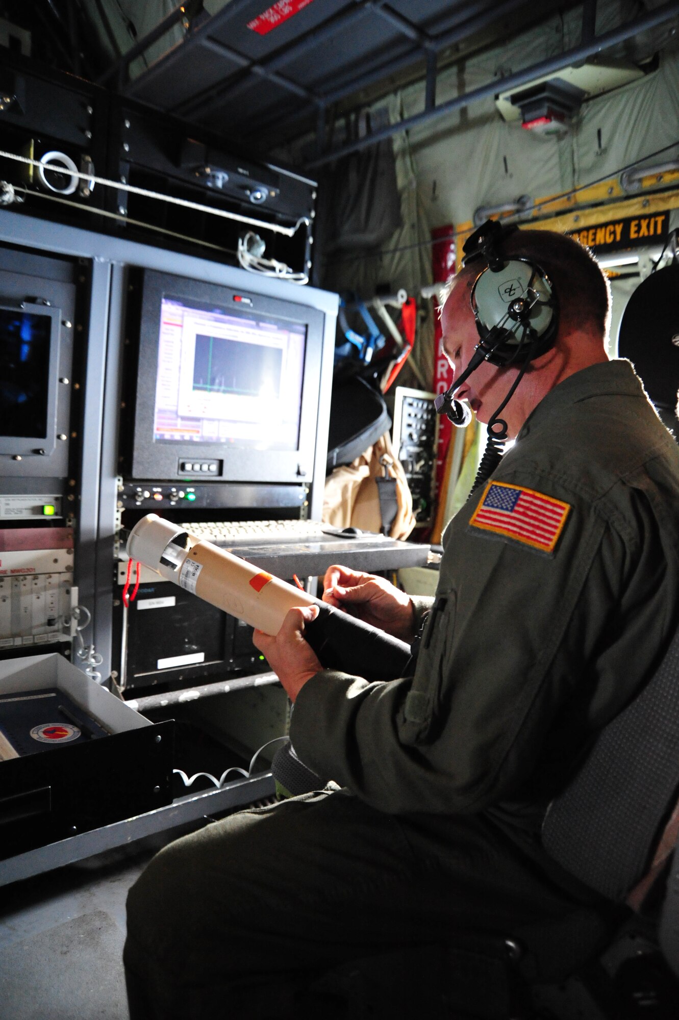 Chief Master Sgt. Troy Peltier, 53rd Weather Reconnaissance Squadron dropsonde operator, ensures his dropsonde weather instrument is functioning correctly before launching it from the bottom of a WC-130J aircraft into the storm, which became known as Hurricane Arthur July 1, 2014. The dropsonde automatically sends weather data, which is critical to the forecasters at the National Hurricane Center, while falling to the water. Once the data is uploaded into the Hurricane Hunter's on-board computers, the data is sent via satellite to NHC personnel, who are then able to update forecast models immediately. These forecast models assist emergency managers and civic leaders in determining the threat level of the storm. (U.S. Air Force photo/Master Sgt. Brian Lamar)