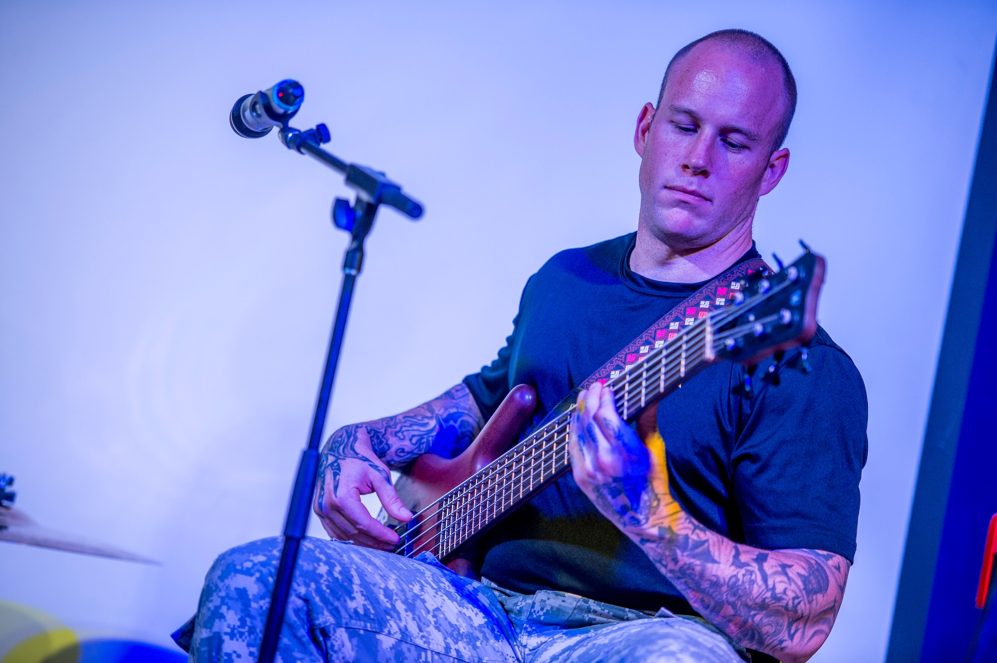 U.S. Army Sgt. Alex Womack, Loose Cannons bass guitarist, plays at the Drop Zone June 2, 2014 at an undisclosed location in Southwest Asia. The band deployed from Fort Bragg, North Carolina for a two week tour across the region performing for the troops in support of Operation Enduring Freedom. (U.S. Air Force photo by Staff Sgt. Jeremy Bowcock)