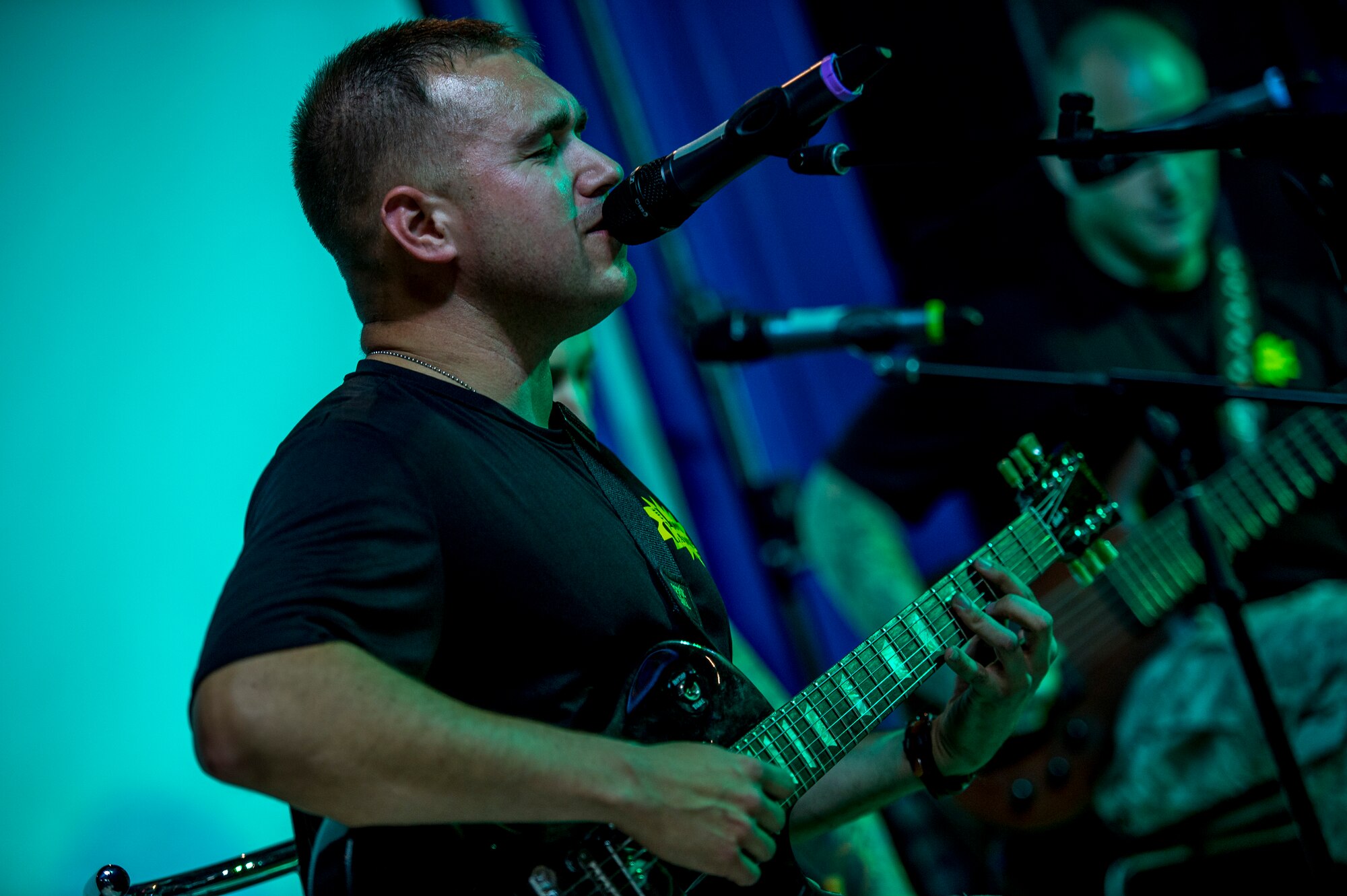 U.S. Army Staff Sgt. Alex Hosay, Loose Cannons guitarist, plays at the Drop Zone June 2, 2014 at an undisclosed location in Southwest Asia. The band deployed from Fort Bragg, North Carolina for a two week tour across the region performing for the troops in support of Operation Enduring Freedom. (U.S. Air Force photo by Staff Sgt. Jeremy Bowcock)