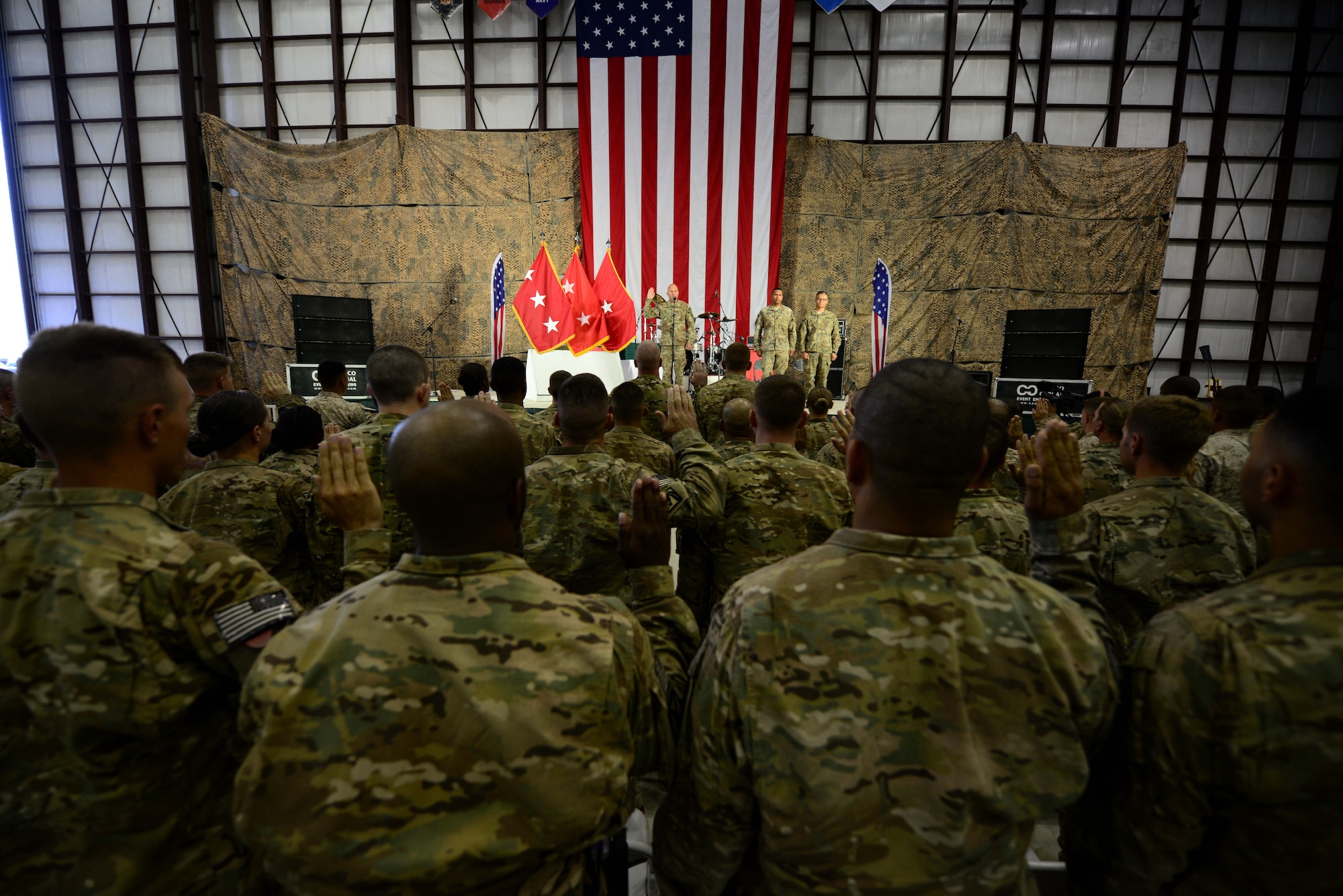 U.S. service members receive the oath of enlistment during a reenlistment ceremony during a Fourth of July celebration at Bagram Airfield, Afghanistan July 4, 2014.  The event was a team effort by the U.S. Air Force and Army to entertain all service members.  (U.S. Air Force photo by Staff Sgt. Evelyn Chavez/Released)