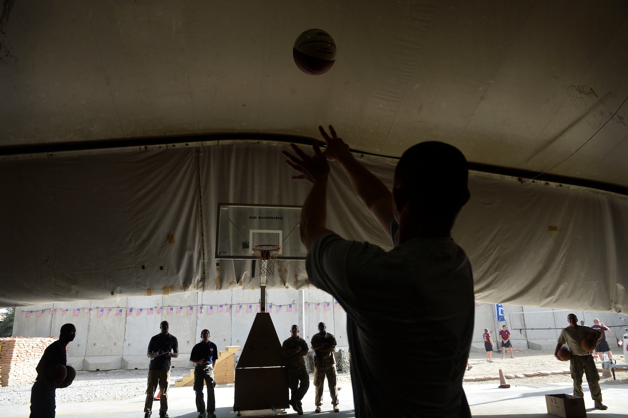 A U.S. Air Force Airman participates in a three point shooting contest during a Fourth of July celebration at Bagram Airfield, Afghanistan July 4, 2014.  The event was a team effort by the U.S. Air Force and Army to entertain all service members.   (U.S. Air Force photo by Staff Sgt. Evelyn Chavez/Released)
