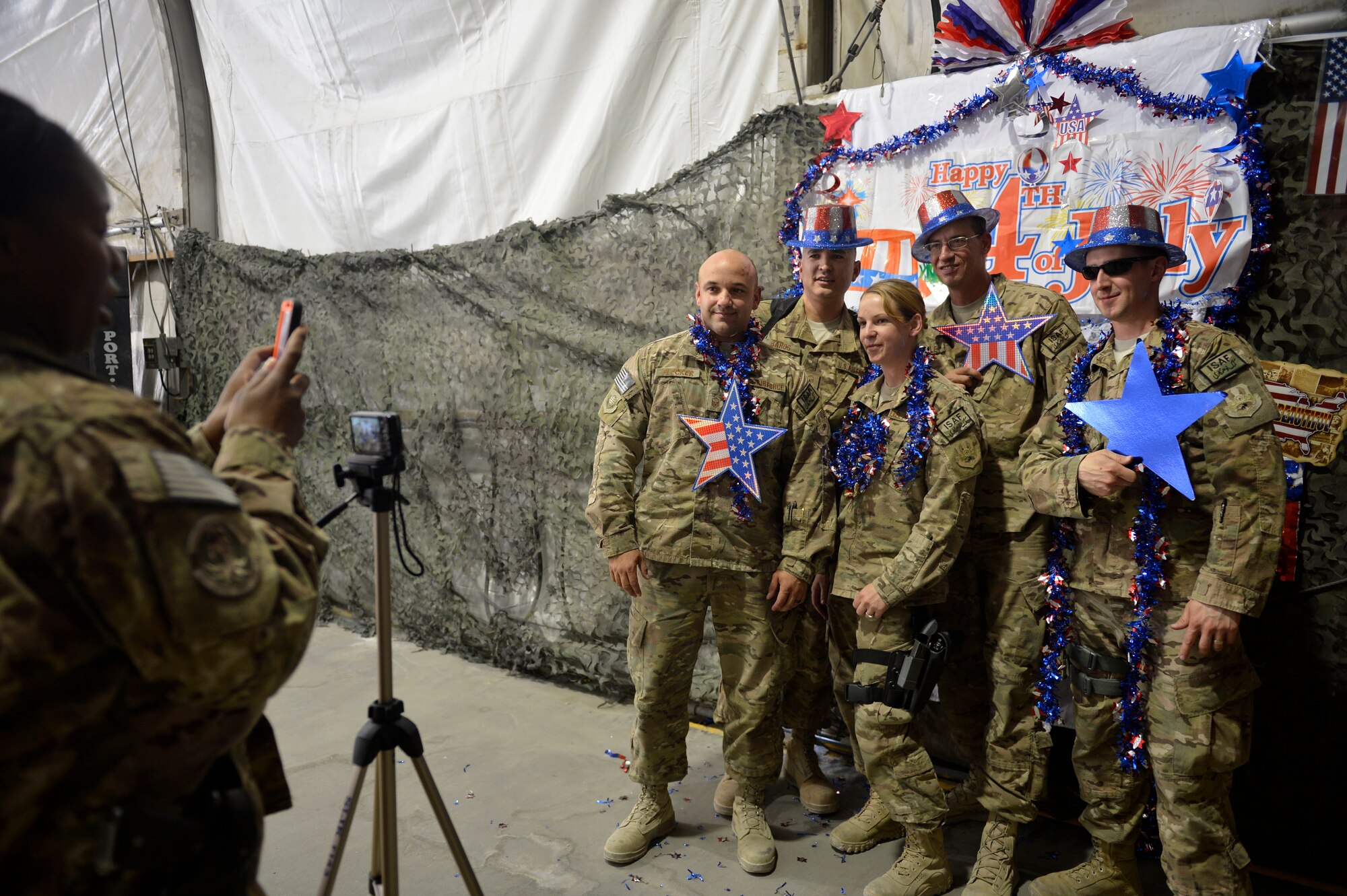 U.S. Air Force Airmen pose for a photograph during a Fourth of July celebration at Bagram Airfield, Afghanistan July 4, 2014.  Food and prizes were given, games such as volleyball and tug-of-war were also played to entertain the service members. (U.S. Air Force photo by Staff Sgt. Evelyn Chavez/Released)