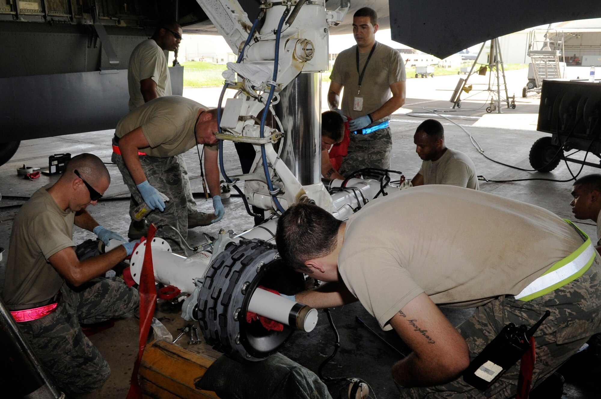 Members of the 718th Aircraft Maintenance Squadron service a KC-135 Stratotanker on Kadena Air Base, Japan, on July 6, 2014, in preparation to evacuate it off of Okinawa in advance of a massive typhoon expected to hit the island on July 8, 2014. Okinawa is susceptible to and threatened by several typhoons each year, but the military personnel are quick to secure their equipment and aircraft from the damaging winds and remain confident that base housing is built to withstand the annual typhoon season.. (U.S. Air Force photo by Senior Airman Marcus Morris)