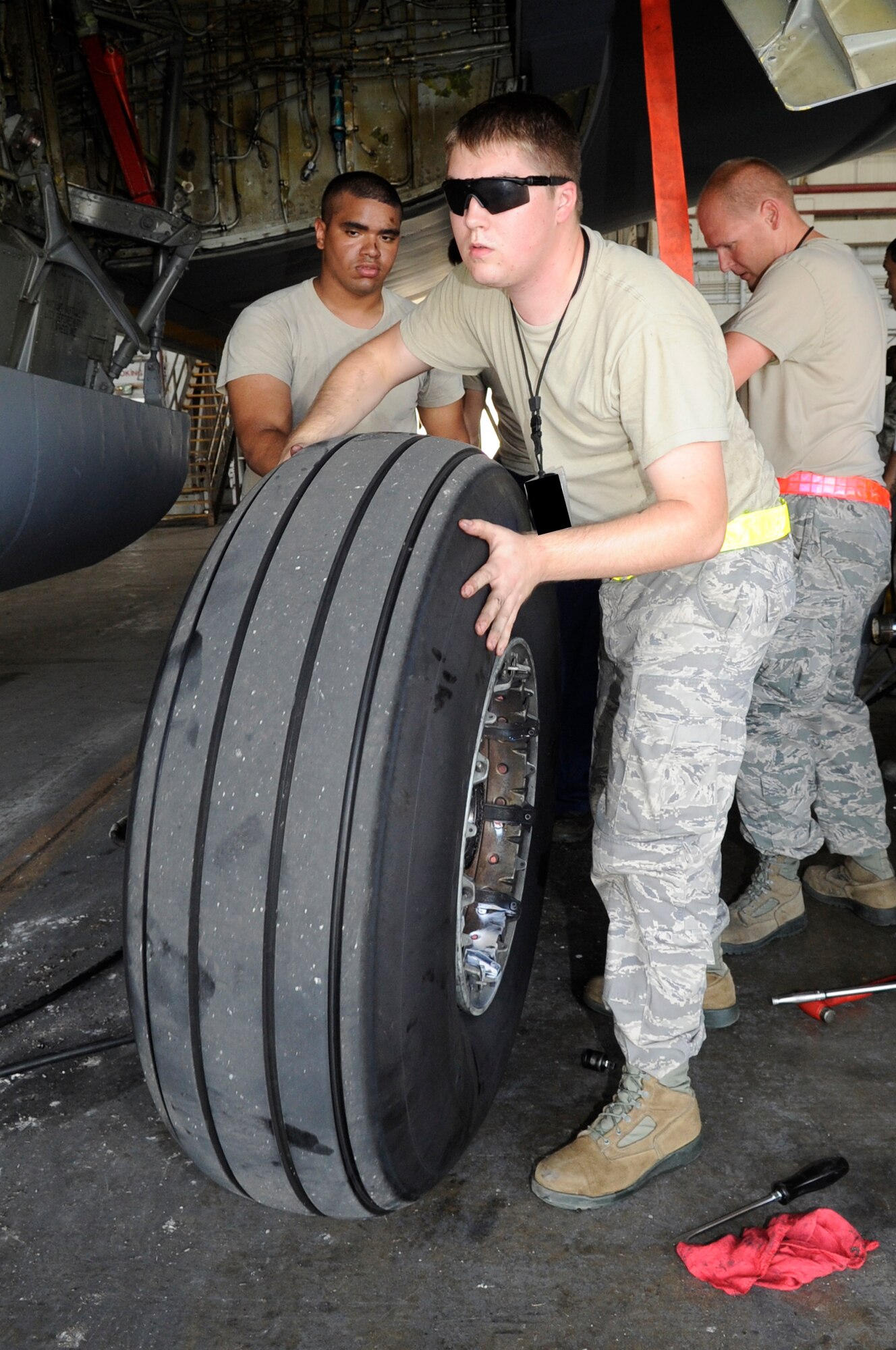 U.S. Air Force Senior Airman Joshua Sloan, 718th Aircraft Maintenance Squadron, replaces a tire on a KC-135 Stratotanker on Kadena Air Base, Japan, July 6, 2014, to prepare it for evacuation off the island in advance of a massive typhoon expected to hit Okinawa on July 8, 2014. Okinawa is susceptible to and threatened by several typhoons each year, but the military personnel are quick to secure their equipment and aircraft from the damaging winds and remain confident that base housing is built to withstand the annual typhoon season. (U.S. Air Force photo by Senior Airman Marcus Morris)