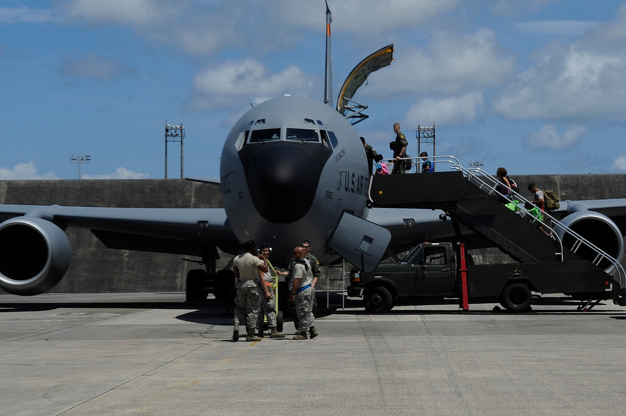 Airmen prepare to deploy from Kadena Air Base, Japan, to the Rim of the Pacific Exercise on July 6, 2014. The Airmen were deploying earlier than planned due to a massive typhoon predicted to hit Okinawa on July 8, 2014, with wind gusts nearing 200 mph. RIMPAC is the world’s largest biennial international maritime training event involving sea and air elements. (U.S. Air Force photo by Senior Airman Marcus Morris)