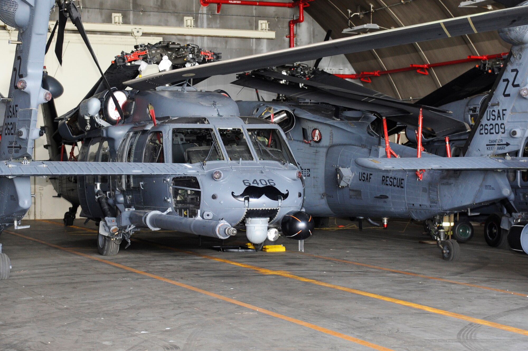 HH-60G Pave Hawk helicopters, assigned to the 33rd Rescue Squadron, are placed into hangars on Kadena Air Base, Japan, July 6, 2014, to protect them from a massive typhoon predicted to slam into Okinawa with wind gusts nearing 200 mph on July 8, 2014. (U.S. Air Force photo by Senior Airman Marcus Morris)