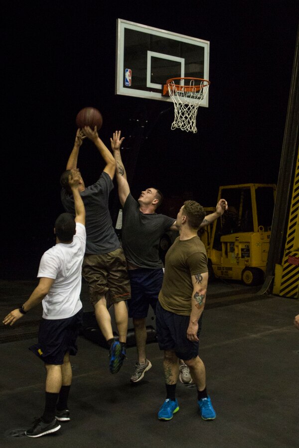 U.S. 5TH FLEET AREA OF RESPONSIBILITY (June 28, 2014) U.S. Marines with 22nd Marine Expeditionary Unit (MEU) and Sailors aboard the amphibious transport dock ship USS Mesa Verde (LPD 19) compete in a game of basketball inside the hangar bay. The 22nd MEU is deployed with the Bataan Amphibious Ready Group as a theater reserve and crisis response force throughout U.S. Central Command and the U.S. 5th Fleet area of responsibility. (U.S. Marine Corps photo by Cpl. Manuel A. Estrada/Released)