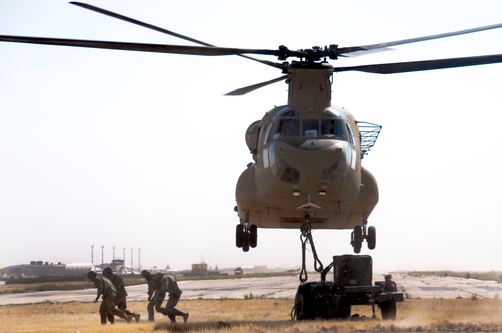 Soldiers assigned to the 1569th Transportation Company make their way out from under the Chinook during practice in Afghanistan recently.