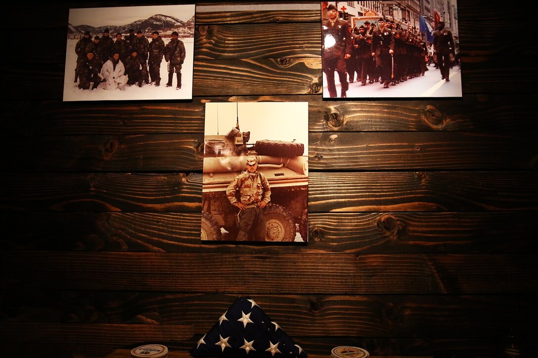 Photos of Col. James Maxwell, a New York State Trooper and Marine, line a wall in honor of Maxwell’s career during his retirement ceremony in New York City, June 26, 2014. Maxwell, a New York State trooper and Marine, served 32 in the Marine Corps. During his career he served in Operation Desert Shield, Operation Desert Storm and Operation Enduring Freedom.