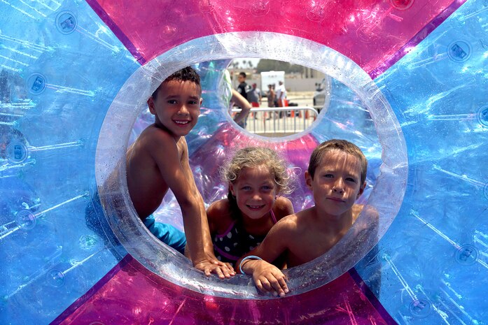 Seven-year-olds Luis, Jayden and Jaylxon spin inside a floating intertude at the Beach Bash at Del Mar Beach here July 4.   

The Beach Bash is an on-base event open to service members, dependents and guests and features  live bands, kids’ activities, a tribute to heroes video, a fireworks show and give-aways.