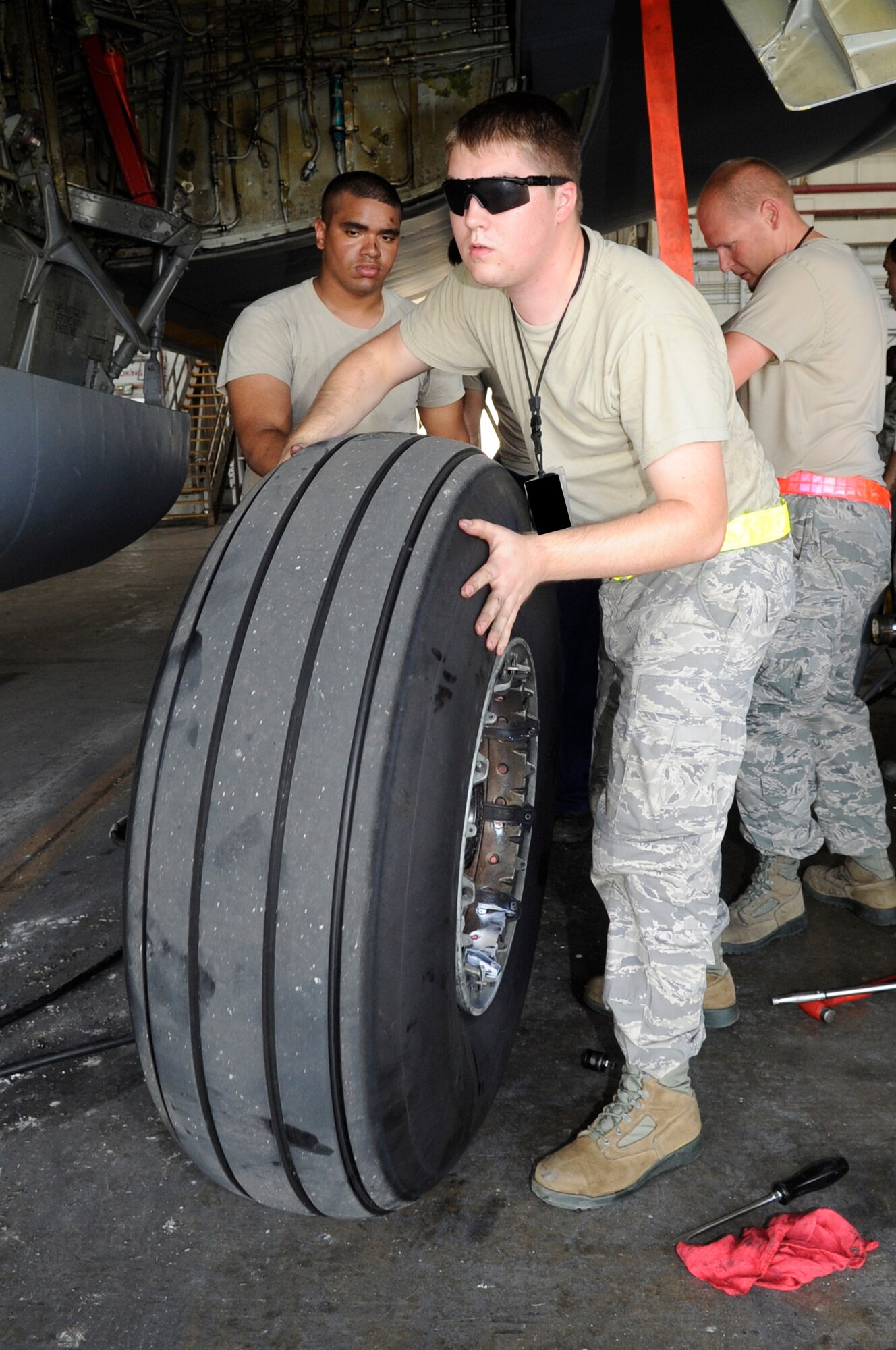 Senior Airman Joshua Sloan replaces a tire on a KC-135 Stratotanker July 6, 2014, on Kadena Air Base, Japan. Airmen began preparing aircraft for evacuation from Okinawa, Japan in advance of a massive typhoon expected to hit the island July 8. Okinawa is susceptible to and threatened by several typhoons each year, but military personnel are quick to secure equipment and aircraft from damaging winds. Sloan is with the 718th Aircraft Maintenance Squadron. (U.S. Air Force photo/Senior Airman Marcus Morris)