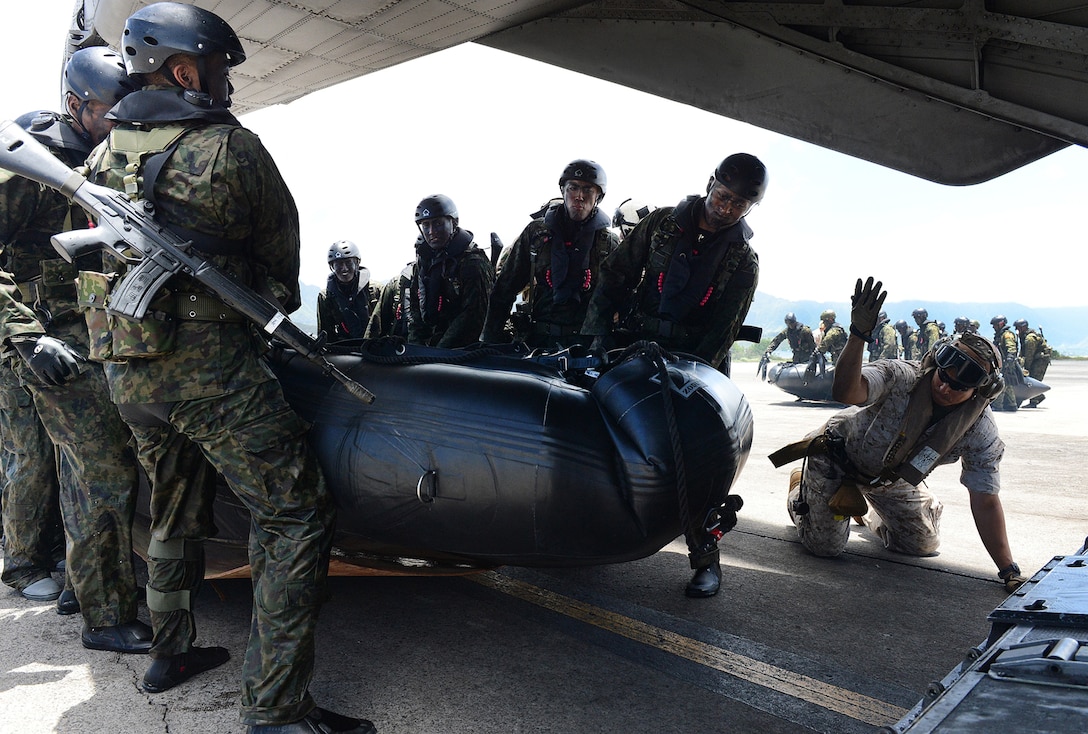 Personnel assigned to the Japan Ground Self-Defense Force load a combat rubber raiding craft into a CH-53E Super Stallion, assigned to Marine Heavy Helicopter Squadron 463, before conducting Helicopter Rope Suspension Training and amphibious insert capabilities with members of 3rd Marine Division, III Marine Expeditionary Force and 3rd Battalion Princess Patricia's Canadian Light Infantry during Rim of the Pacific Exercise 2014. RIMPAC provides a unique training opportunity that helps participants foster and sustain the cooperative relationships that are critical to ensuring the safety of sea lanes and security on the world's oceans. Twenty-two nations, more than 49 ships, six submarines, more than 200 aircraft and 25,000 personnel are participating in RIMPAC. (U.S. Navy photo by Mass Communication Specialist 1st Class Shannon E. Renfroe/Released)