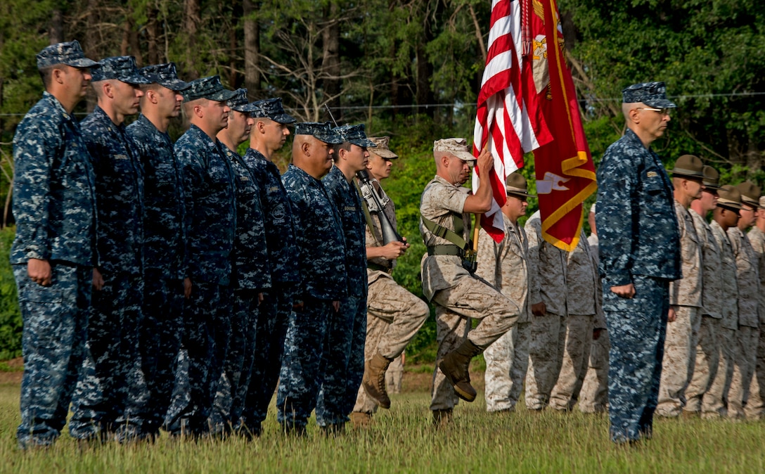 Service members stand at attention for the presenting of the colors for the 53rd Annual Interservice Rifle Championship at Range 4, Weapon Training Battalion aboard Marine Corps Base Quantico July 6. Competitors from every branch of service will face off in 15 matches in seven days, which test them as individuals and teams. 