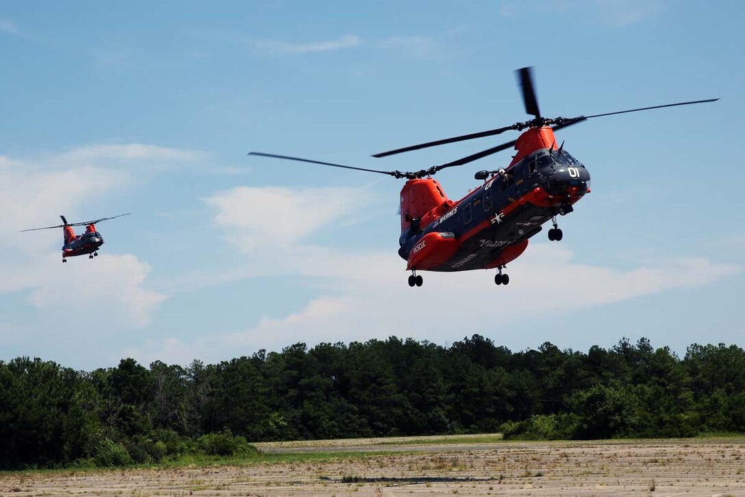 Two HH-46 Sea Knight helicopters from Marine Transport Squadron 1 arrive at Marine Corps Outlying Field Atlantic, N.C., June 25, 2014.  The Sea Knights carried Department of Defense and Office of Management and Budget officials who toured Marine Corps Air Station Cherry Point, N.C., and its outlying training facilities to learn about Cherry Point’s efforts to prevent further encroachment upon critical training.