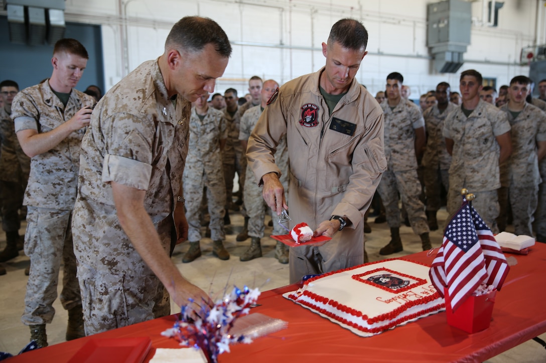 Lieutenant Col. Robert M. Kudelko (right) and Col. Eric Austin (left) take part in a cake-cutting ceremony during an observance commemorating the 39th birthday of Marine Tactical Electronic Warfare Squadron 2 at Marine Corps Air Station Cherry Point, N.C., July 1, 2014. The squadron is the oldest electronic warfare squadron in the Marine Corps today. Austin is the commanding officer of Marine Aircraft Group 14 and Kudelko is the commanding officer of VMAQ-2. 